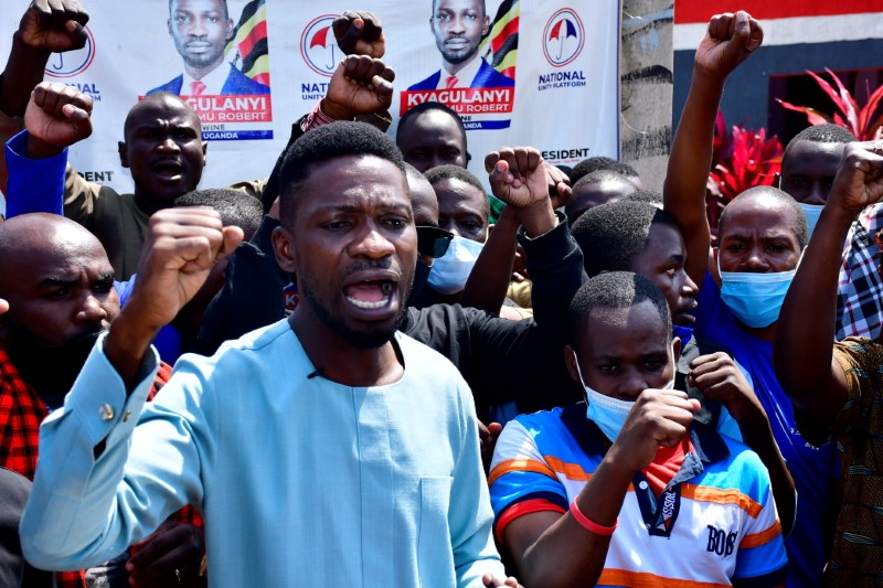 Former presidential candidate Robert Kyagulanyi, also known as Bobi Wine, gestures as he speaks during a news event after members of his security detail were released on bail, at his party's headquarters in Kampala