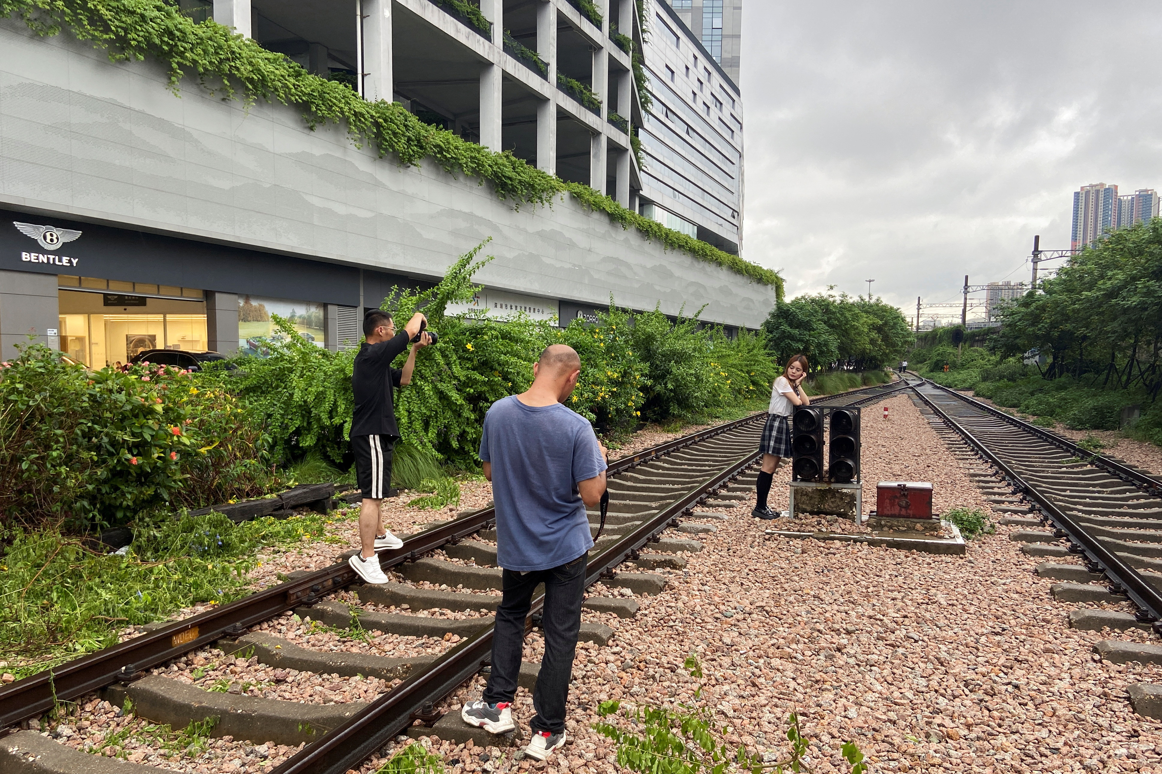 Woman poses for photos on the old rail route to Hong Kong, in Shenzhen