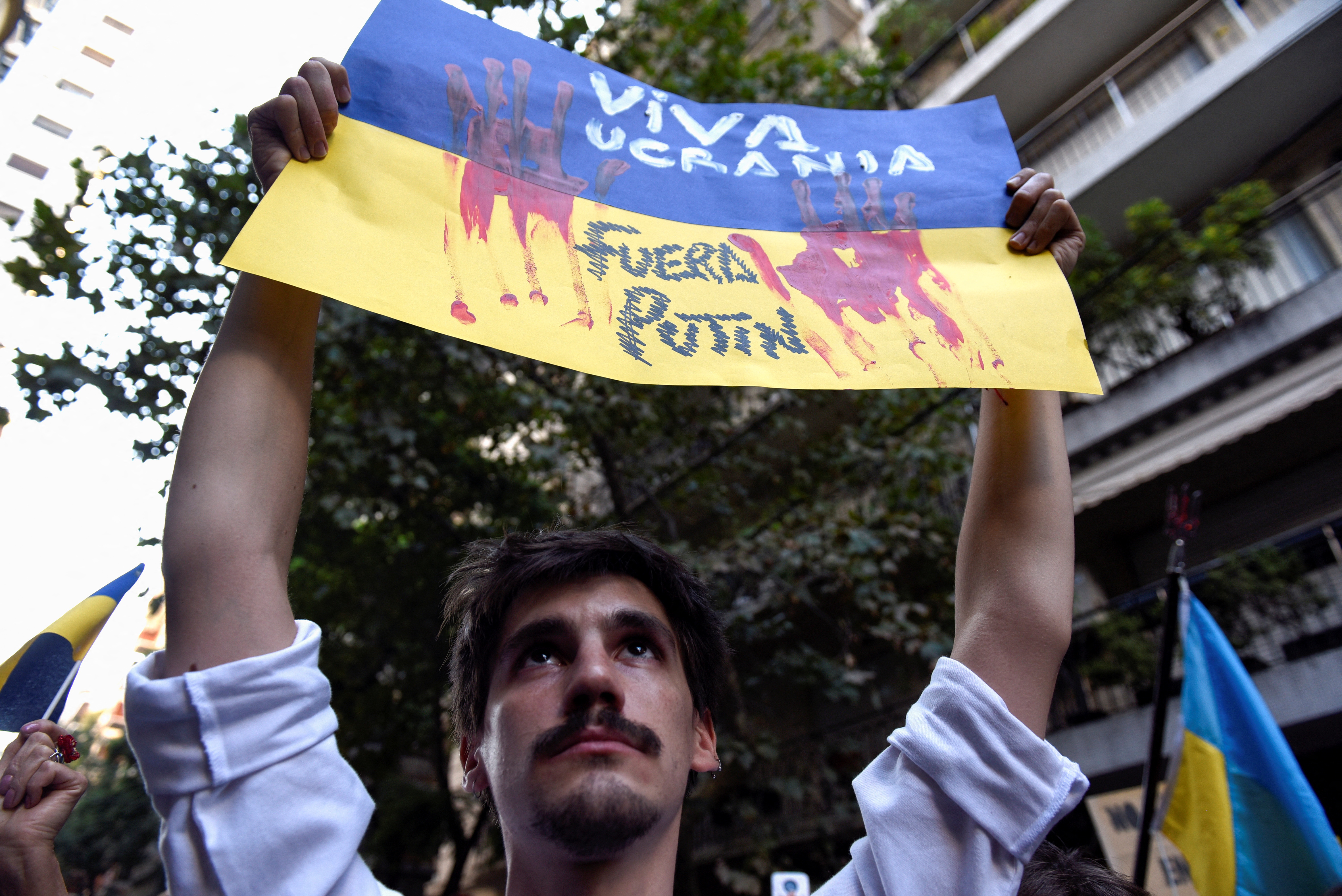 She woke up with bombs': Ukrainian diasporas in Latin America protest  invasion | Reuters