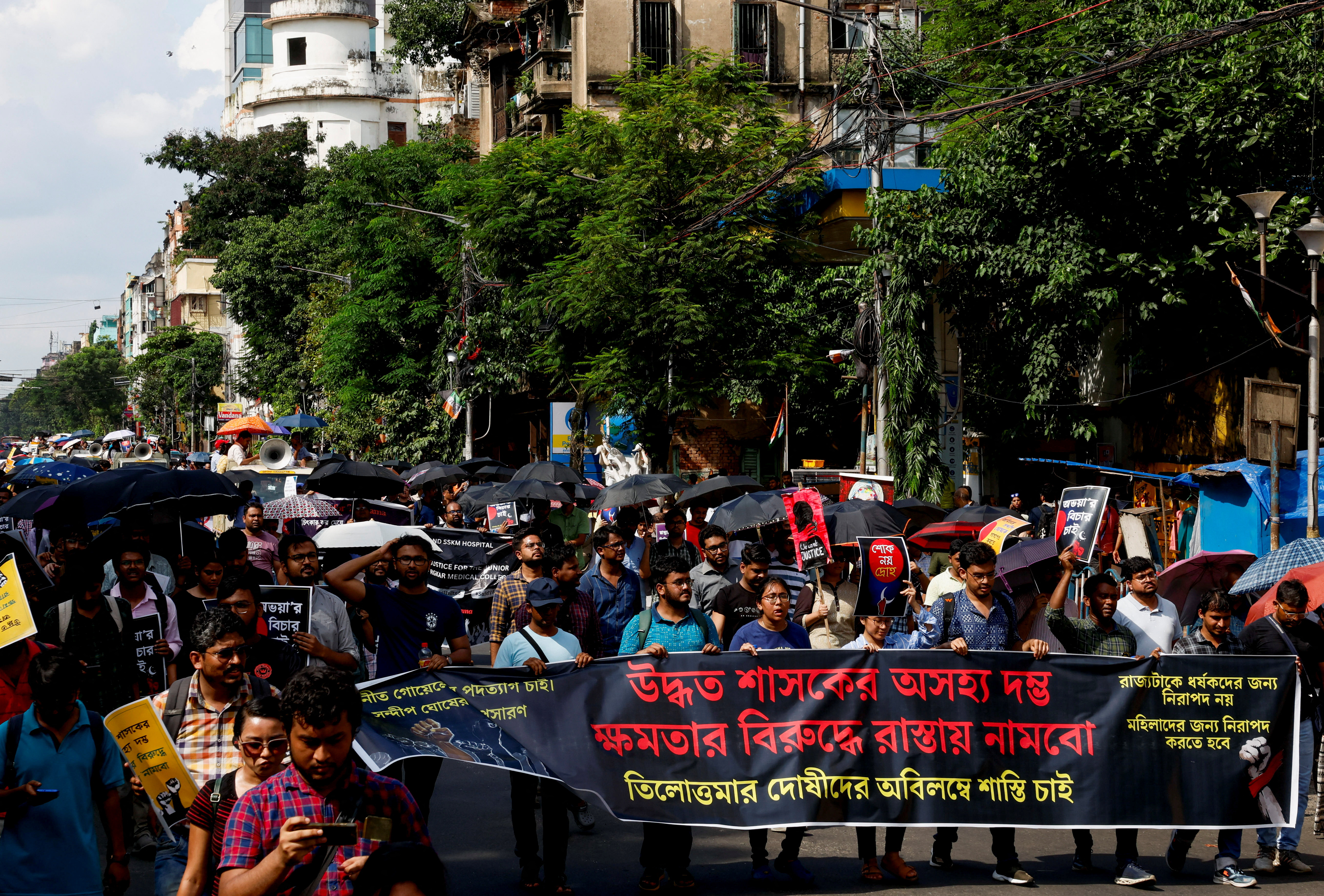 Medics march along a street during a protest condemning the rape and murder of a trainee medic at a government-run hospital, in Kolkata