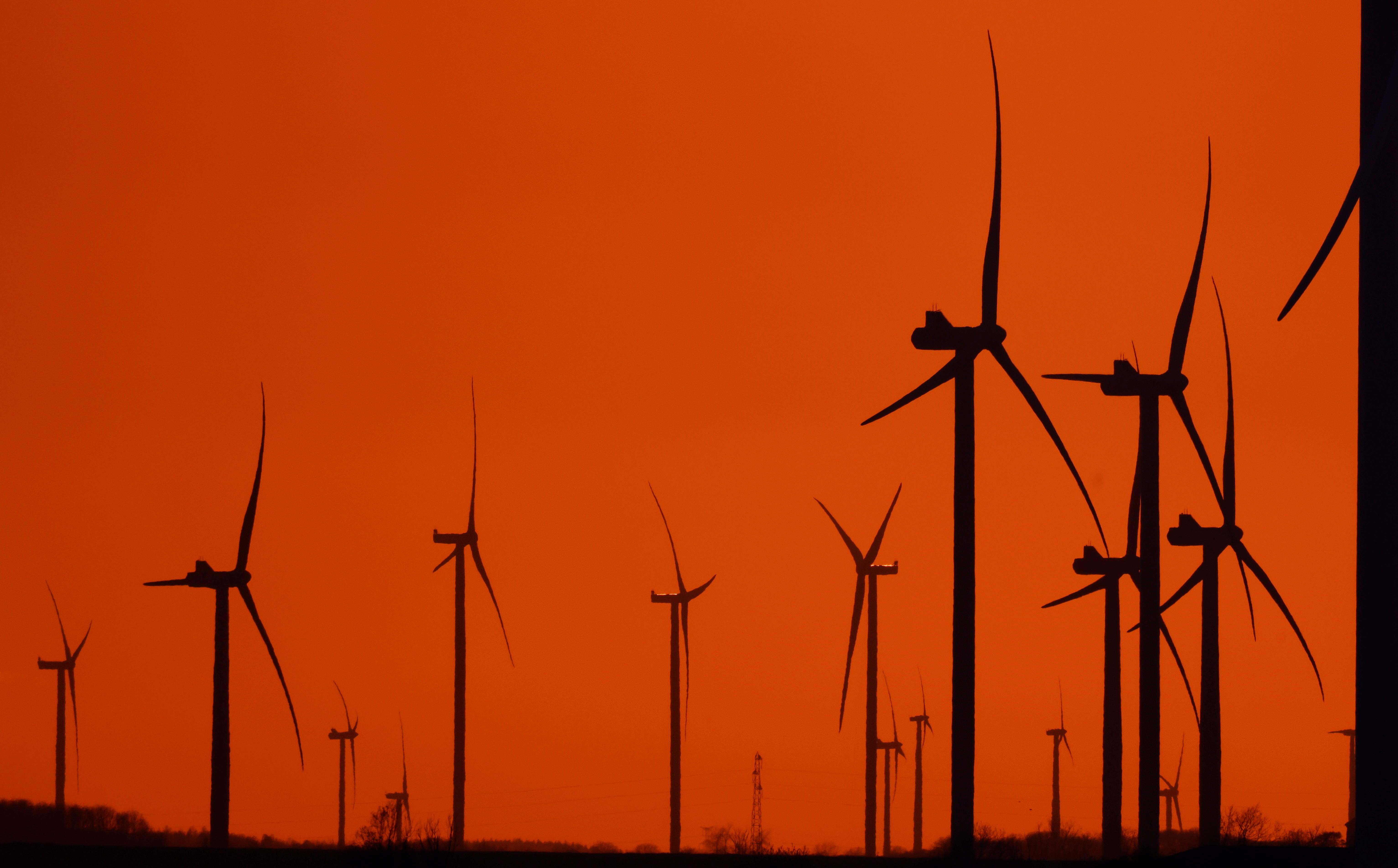 Power-generating windmill turbines are pictured during sunset at a wind park in Havrincourt