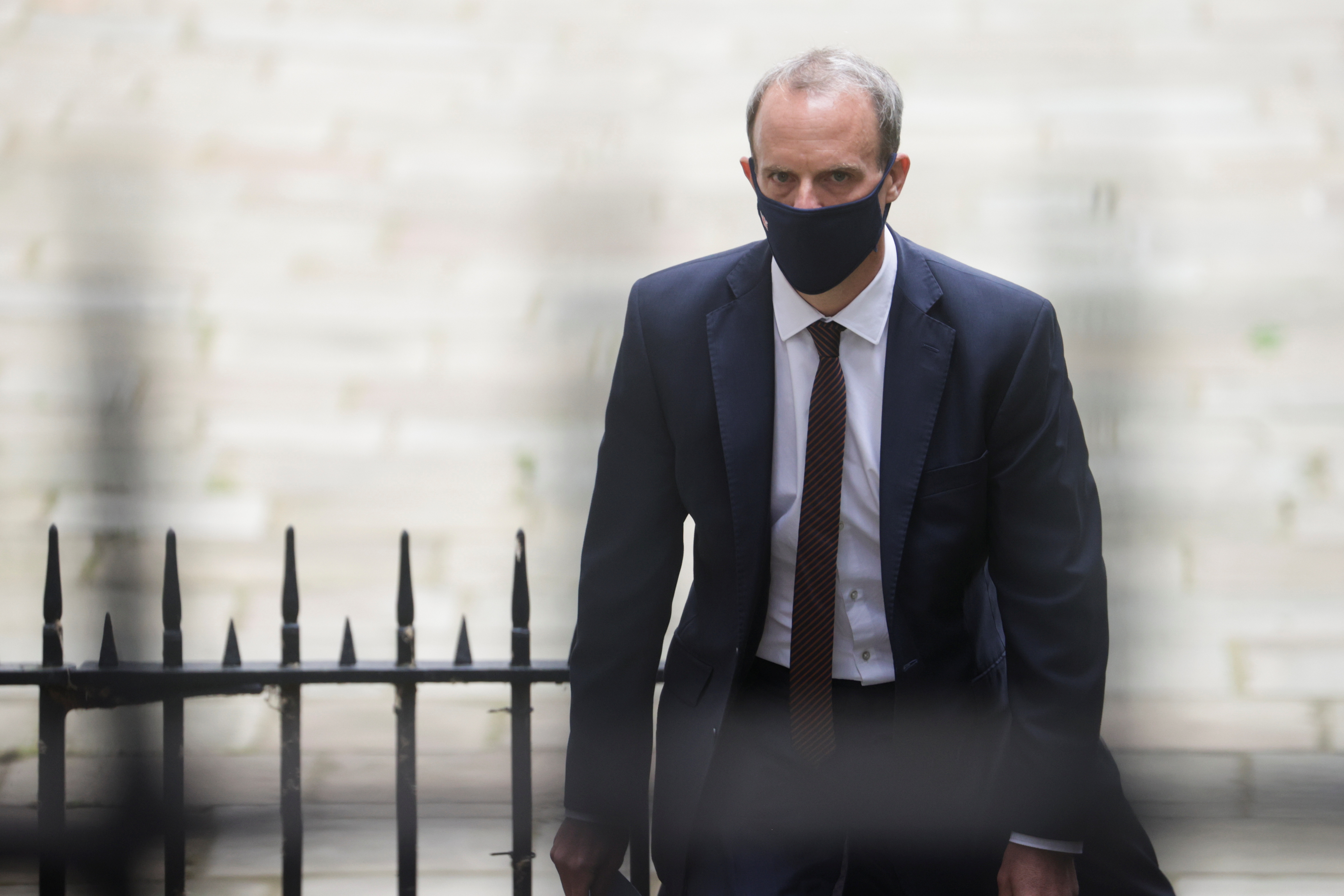 Britain's Foreign Secretary Dominic Raab walks outside Downing Street, in London