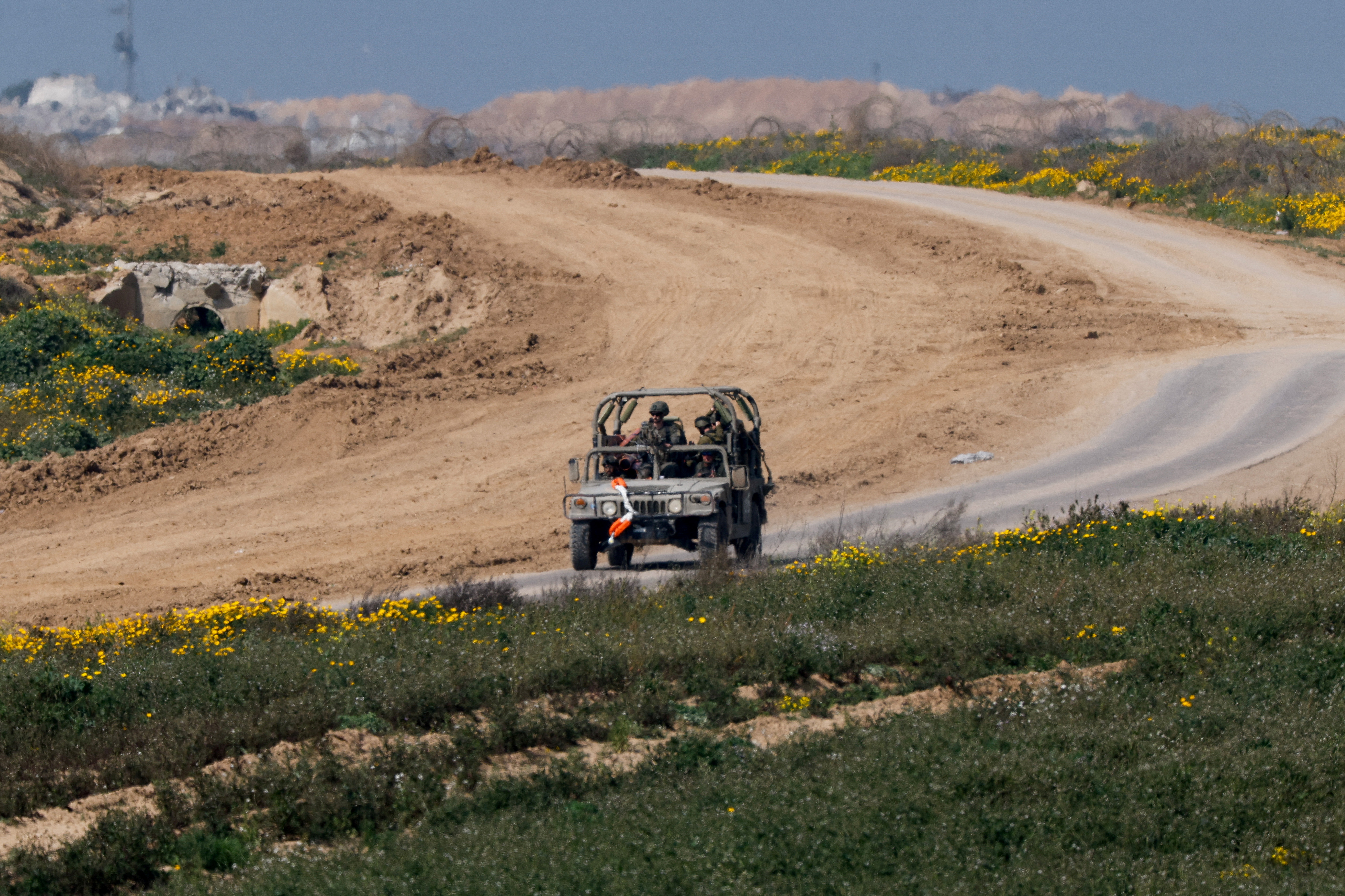 A military vehicle maneuvres near the Israel-Gaza border