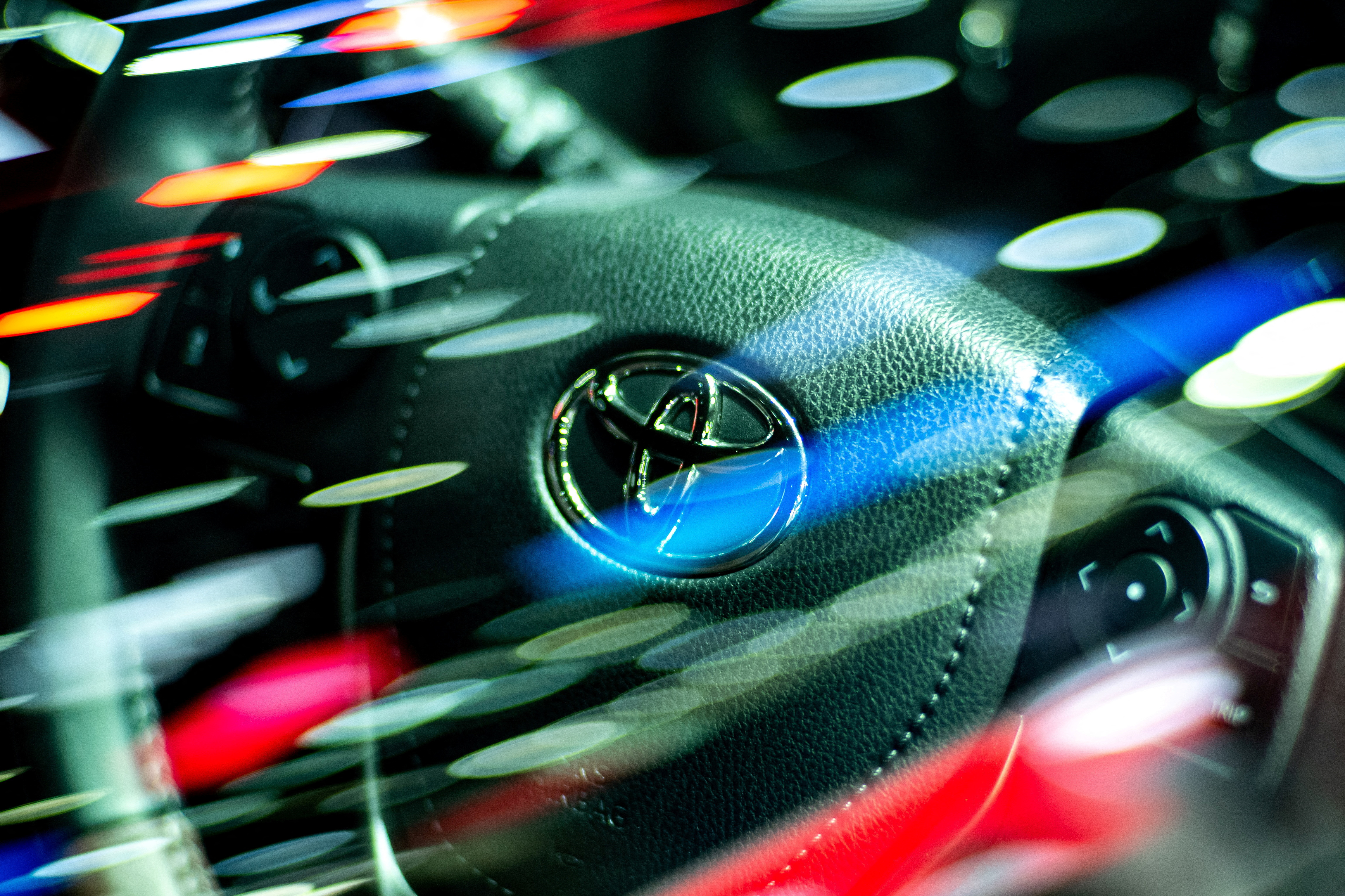The logo of Toyota Motor is seen on a steering wheel inside a Vios model