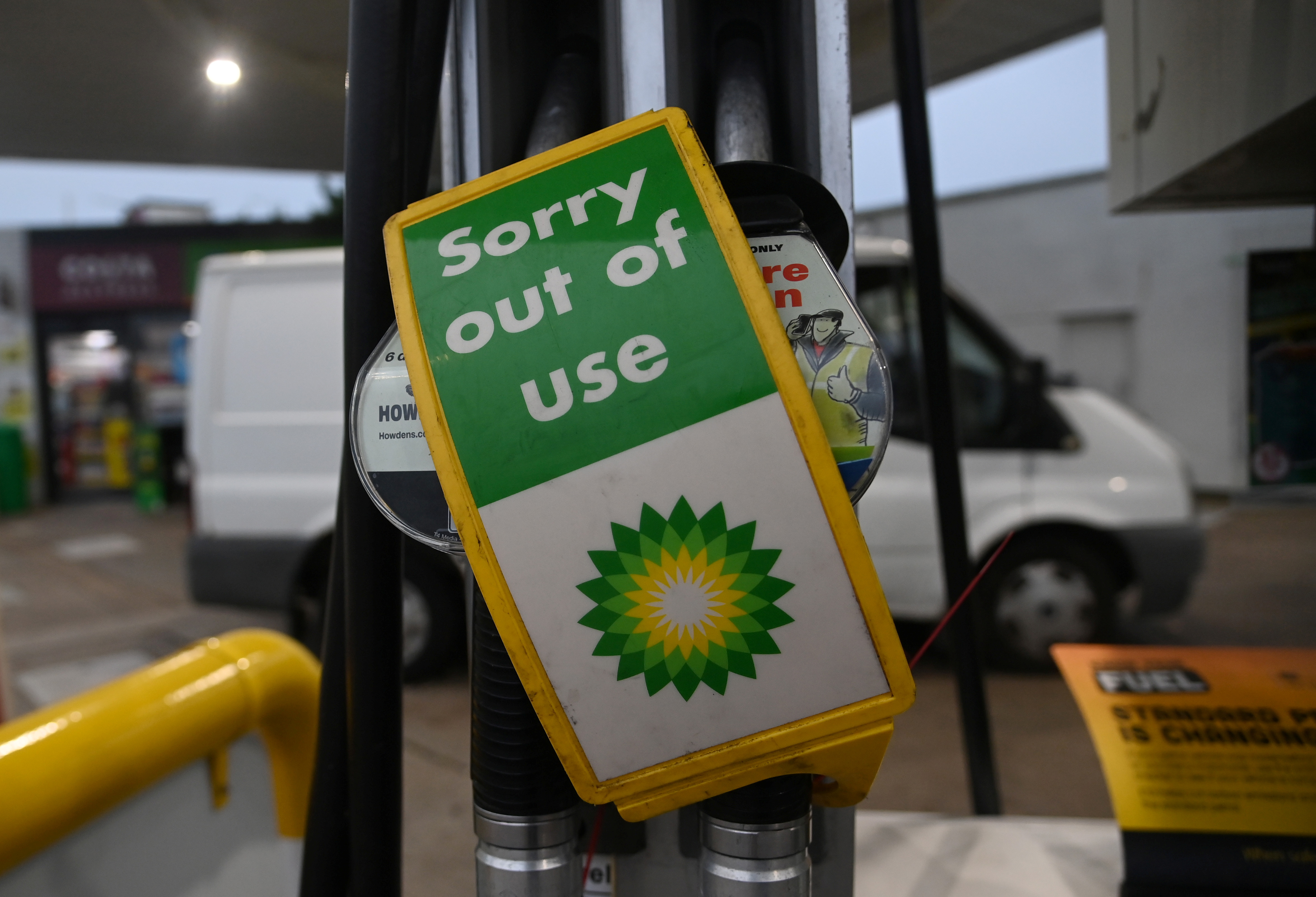 “Out of use” signs are placed over pumps at a petrol station in London, Britain, September 24, 2021. REUTERS/Toby Melville