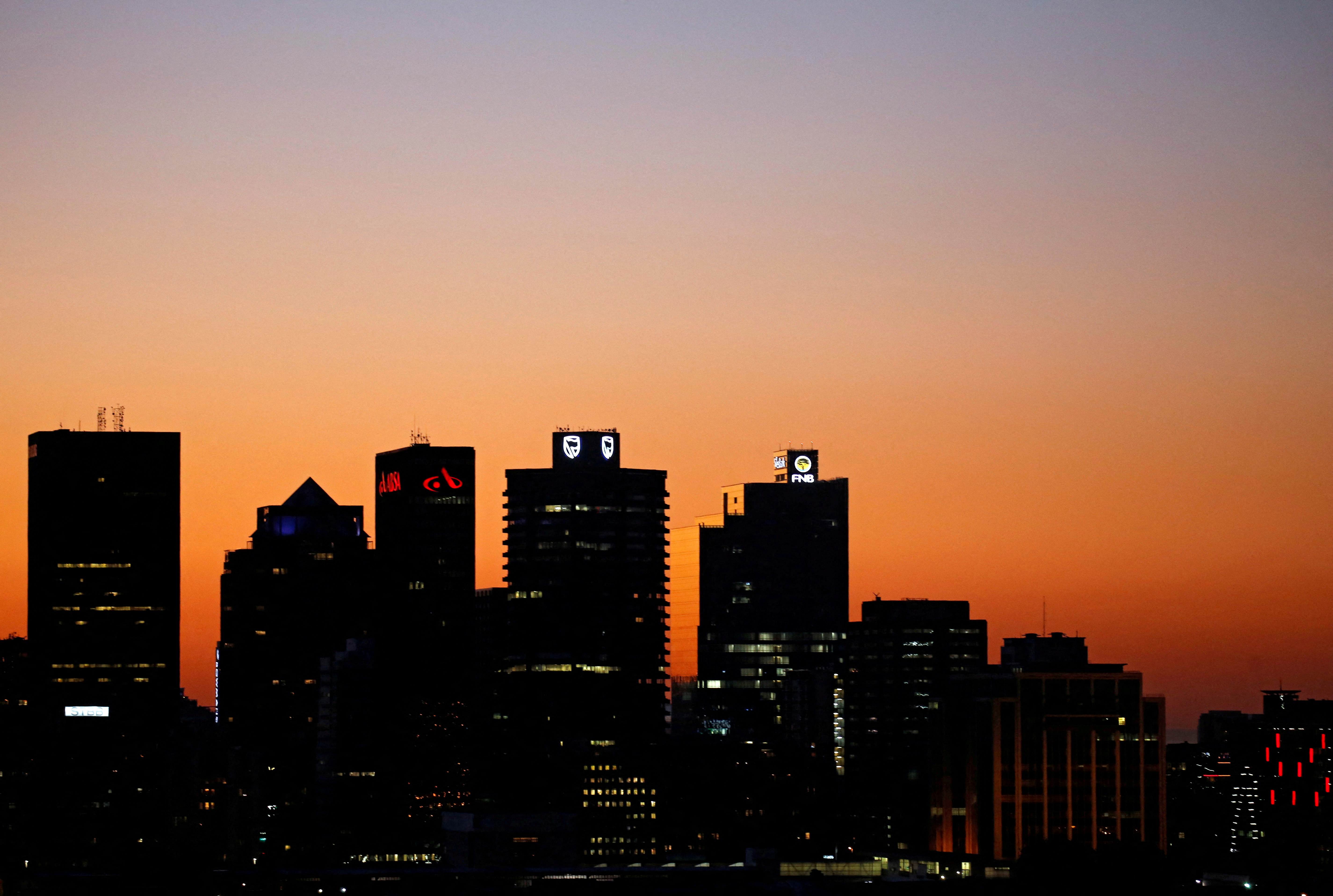 The buildings with the logos of three of South Africa's biggest banks, ABSA, Standard Bank and First National Bank are seen against the city skyline in Cape Town