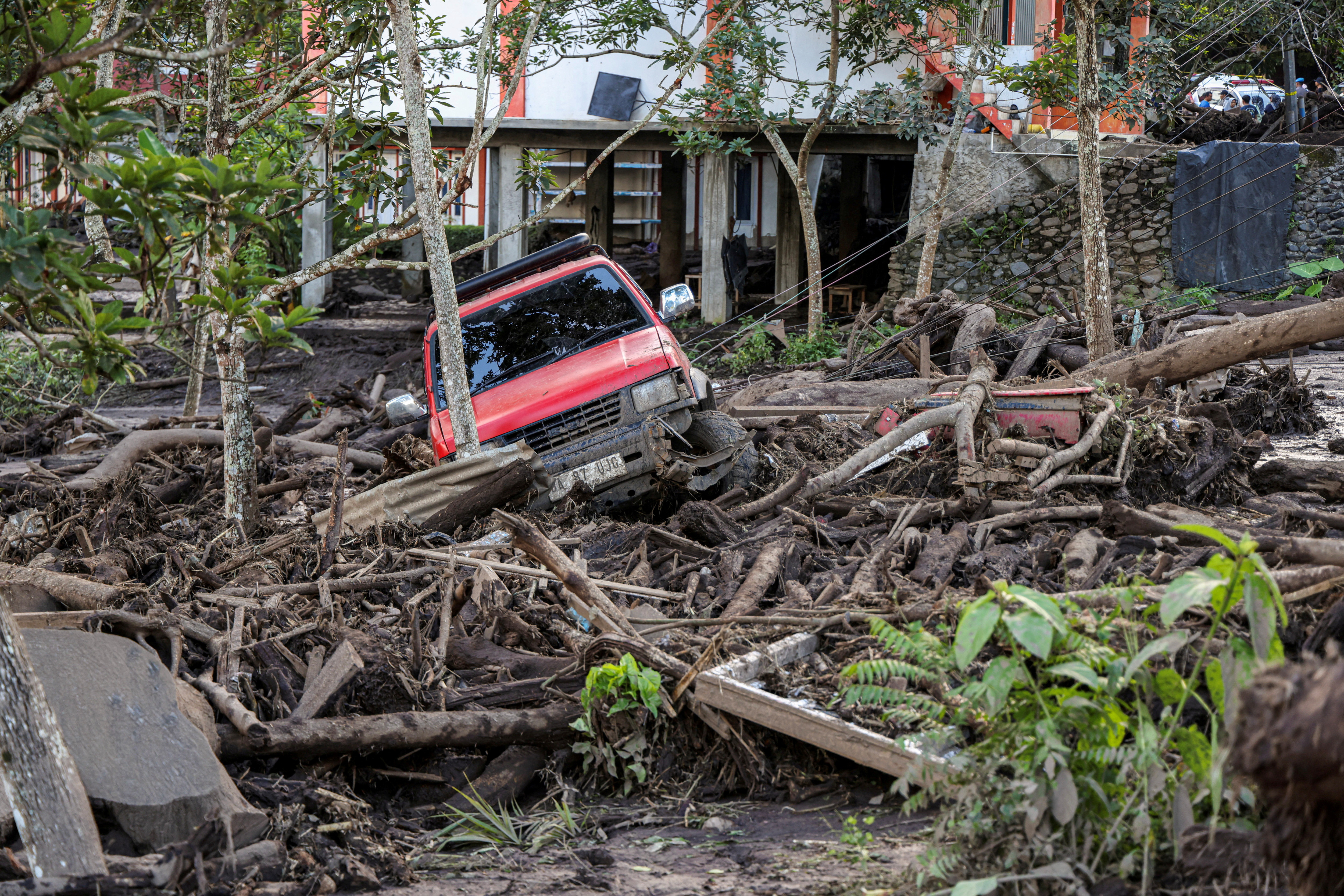 A damaged car is seen in an area affected by heavy rain brought flash floods and landslides in Tanah Datar