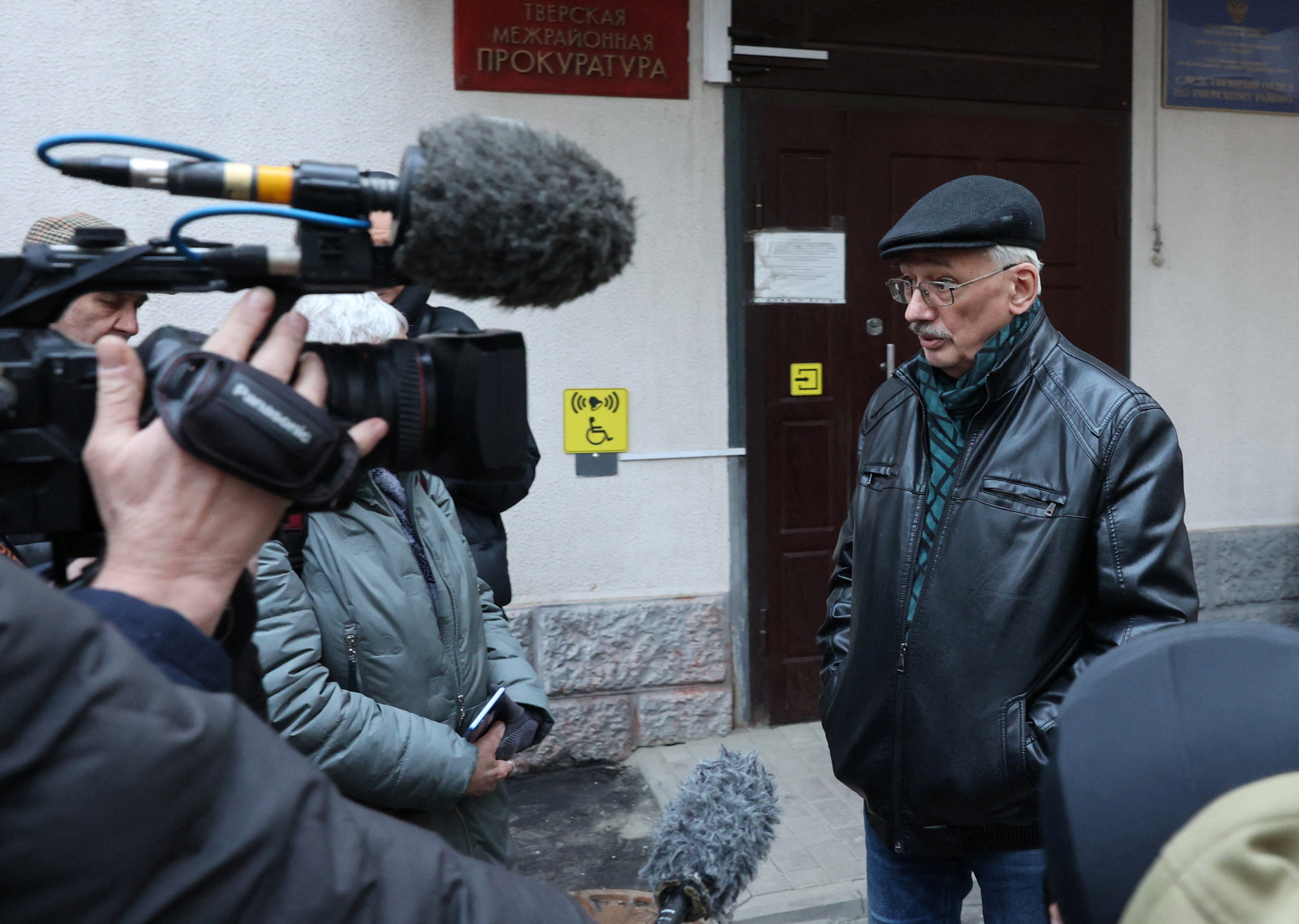 Oleg Orlov, chairman of Russian human rights centre Memorial, speaks to journaists outside Russian Investigative Committee in Moscow