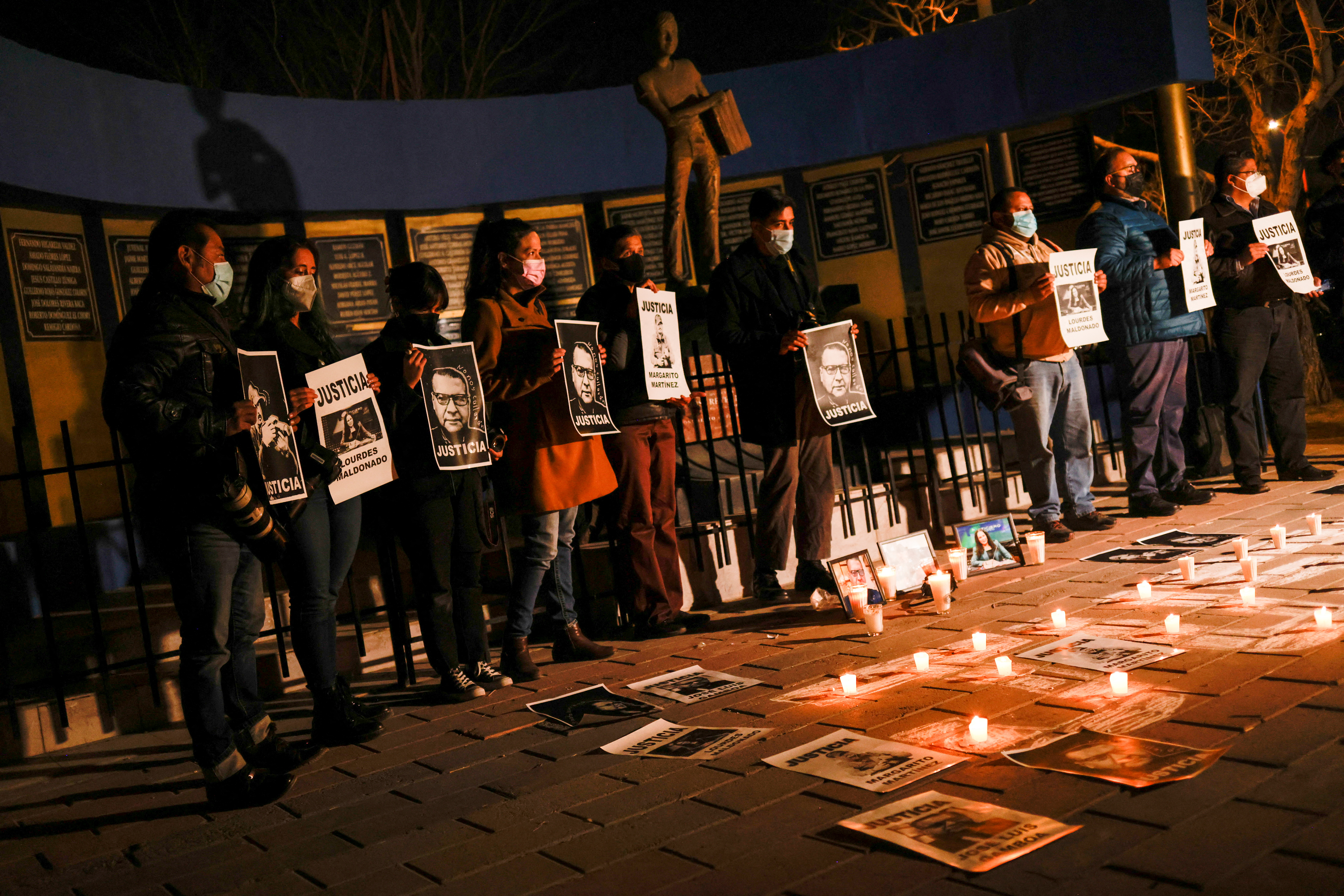 Journalists hold photos of deceased journalists during a vigil demanding justice and protection from the federal government following the killings of three colleagues on past days, in the Journalist's Square in Ciudad Juarez, Mexico, January 25, 2022. REUTERS/Jose Luis Gonzalez