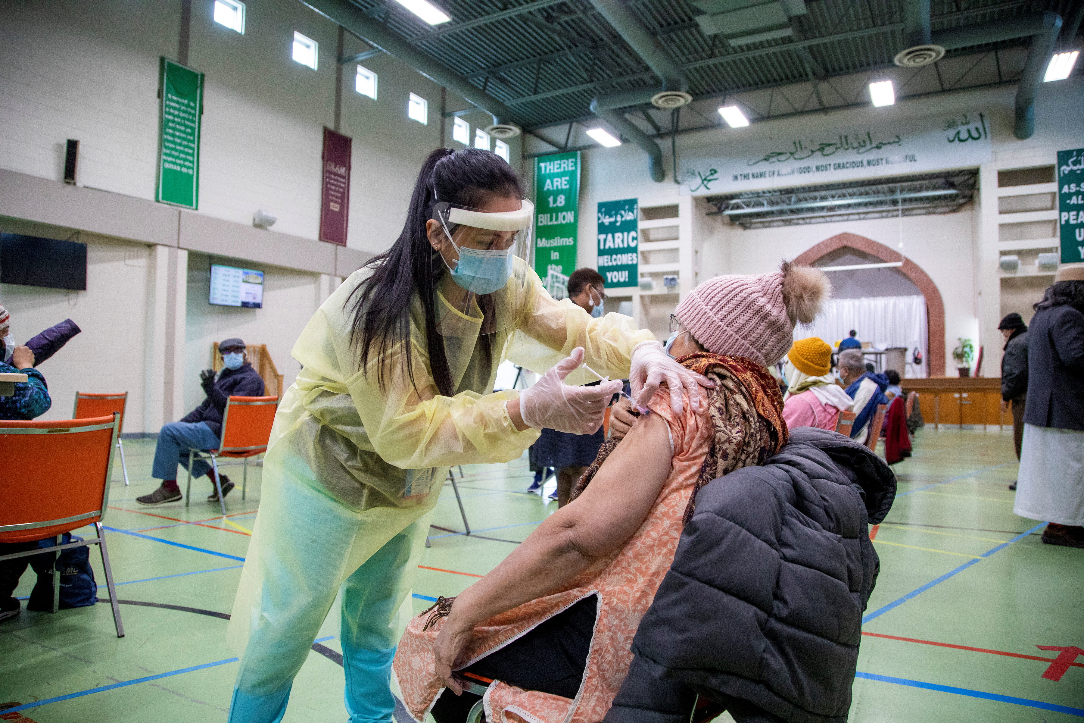 Nurses from Humber River Hospital's mobile vaccine clinic administer the Moderna COVID-19 vaccine at Toronto and Region Islamic Congregation Centre as part of the coronavirus disease (COVID-19) vaccination campaign, in Toronto, Ontario, Canada April 1, 2021. REUTERS/Carlos Osorio