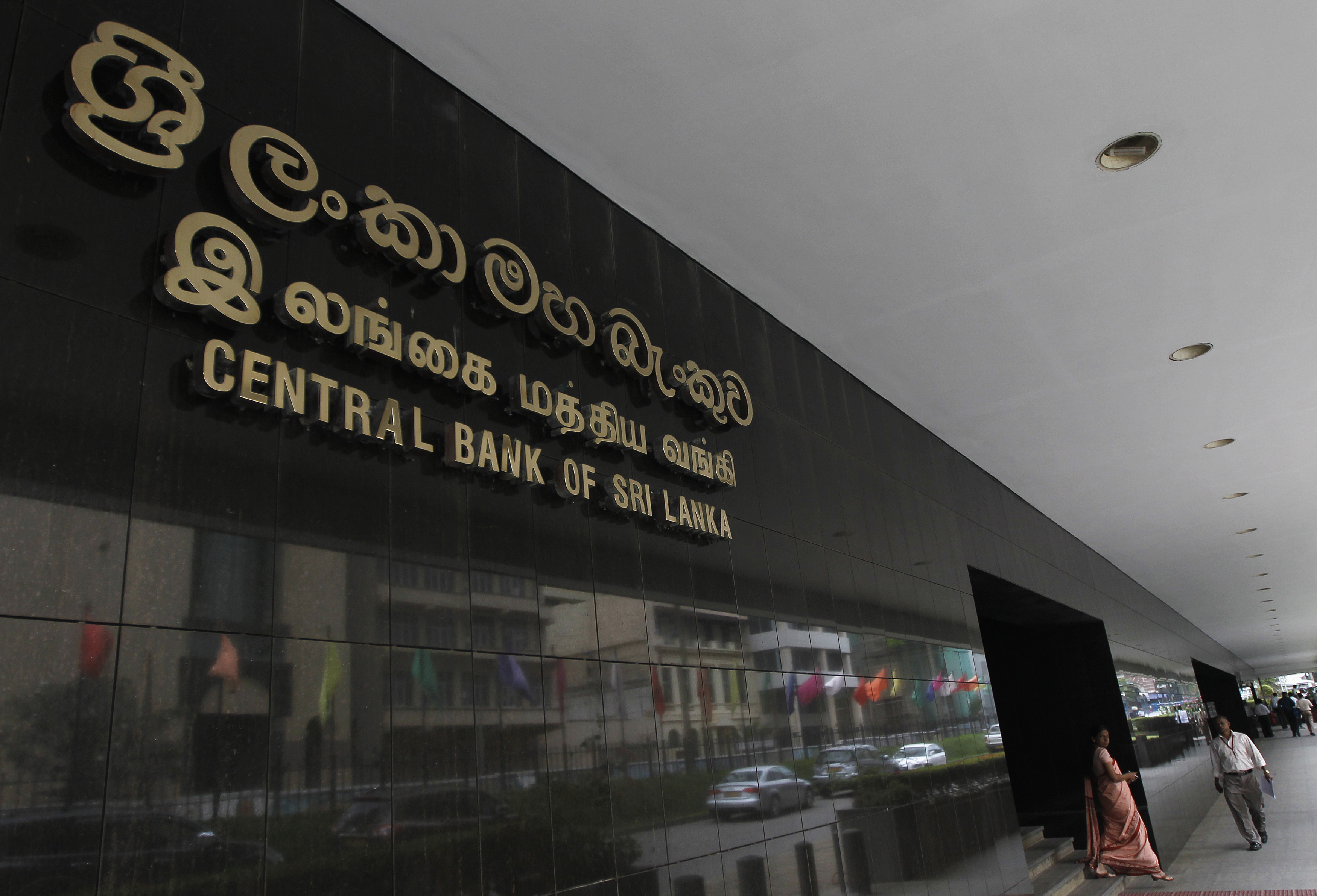People walk at the Central Bank of Sri Lanka building in Colombo