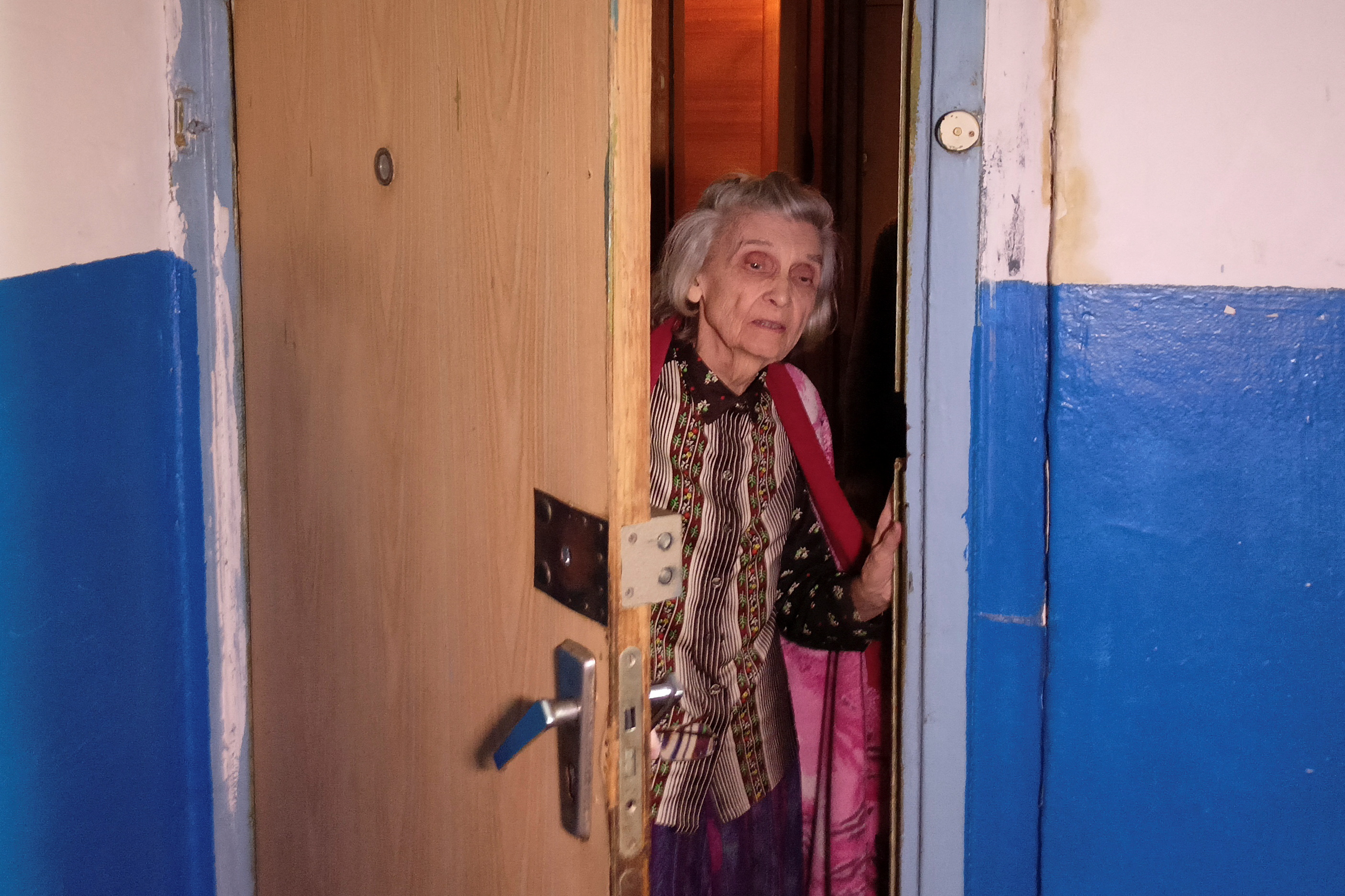 Margarita Morozova, 87, who survived the siege of Leningrad during World War II, looks out of her apartment in Kharkiv
