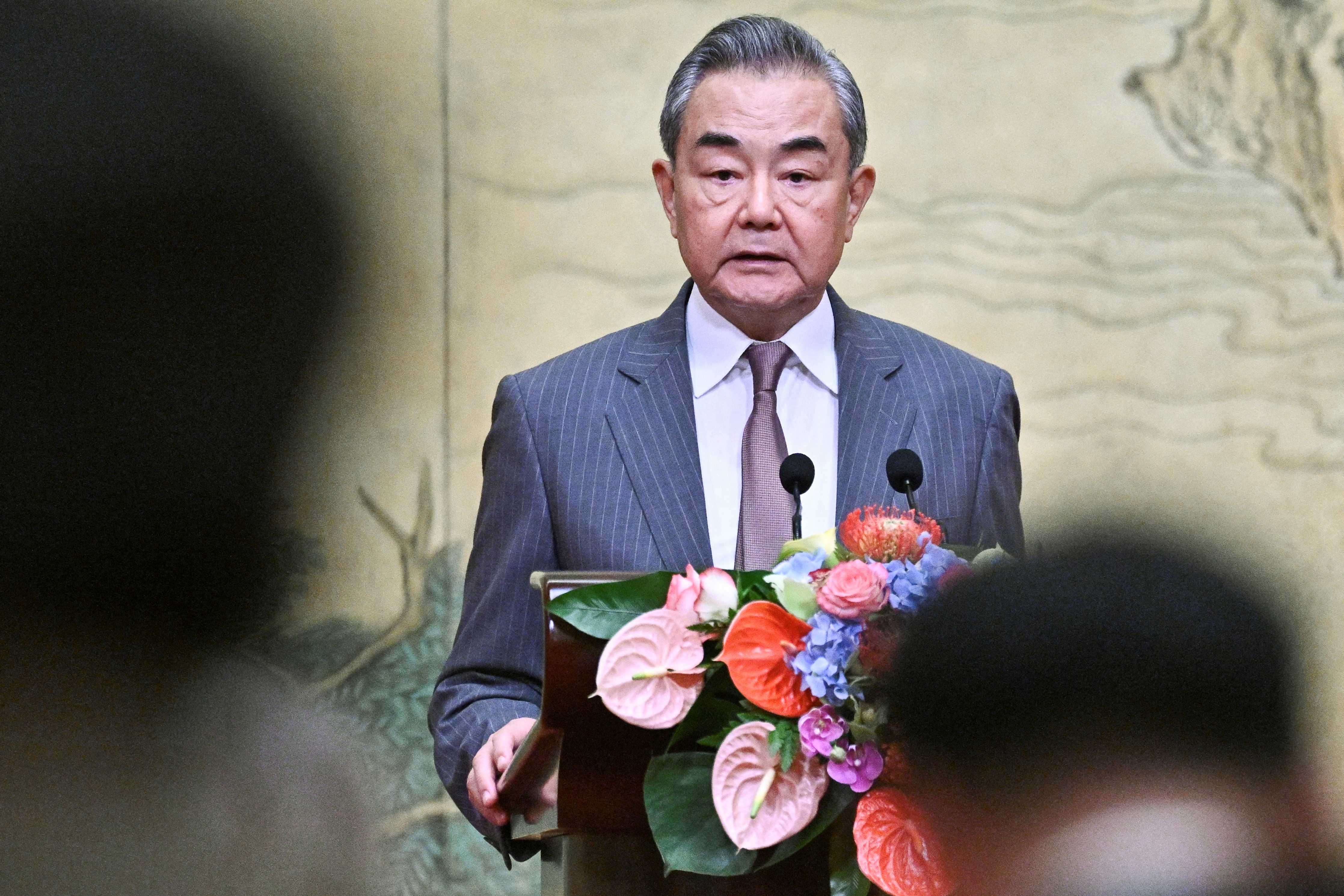 China's Foreign Minister Wang Yi hosts Vice Chairman of the Central Committee of Fatah, Mahmoud al-Aloul and senior member of Hamas, Mussa Abu Marzuk, at the Diaoyutai State Guesthouse in Beijing