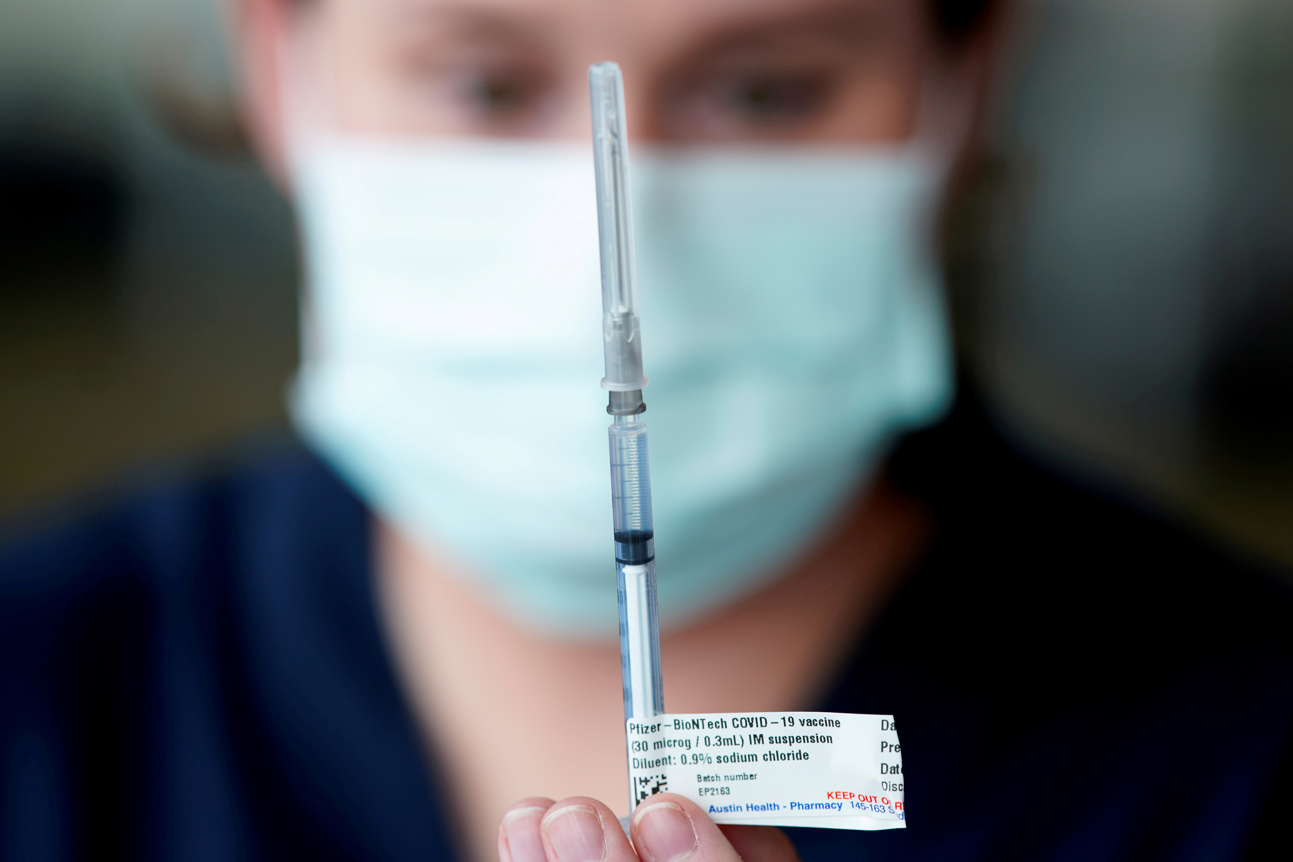 The Pfizer COVID-19 vaccine is prepared by a healthcare worker in Melbourne