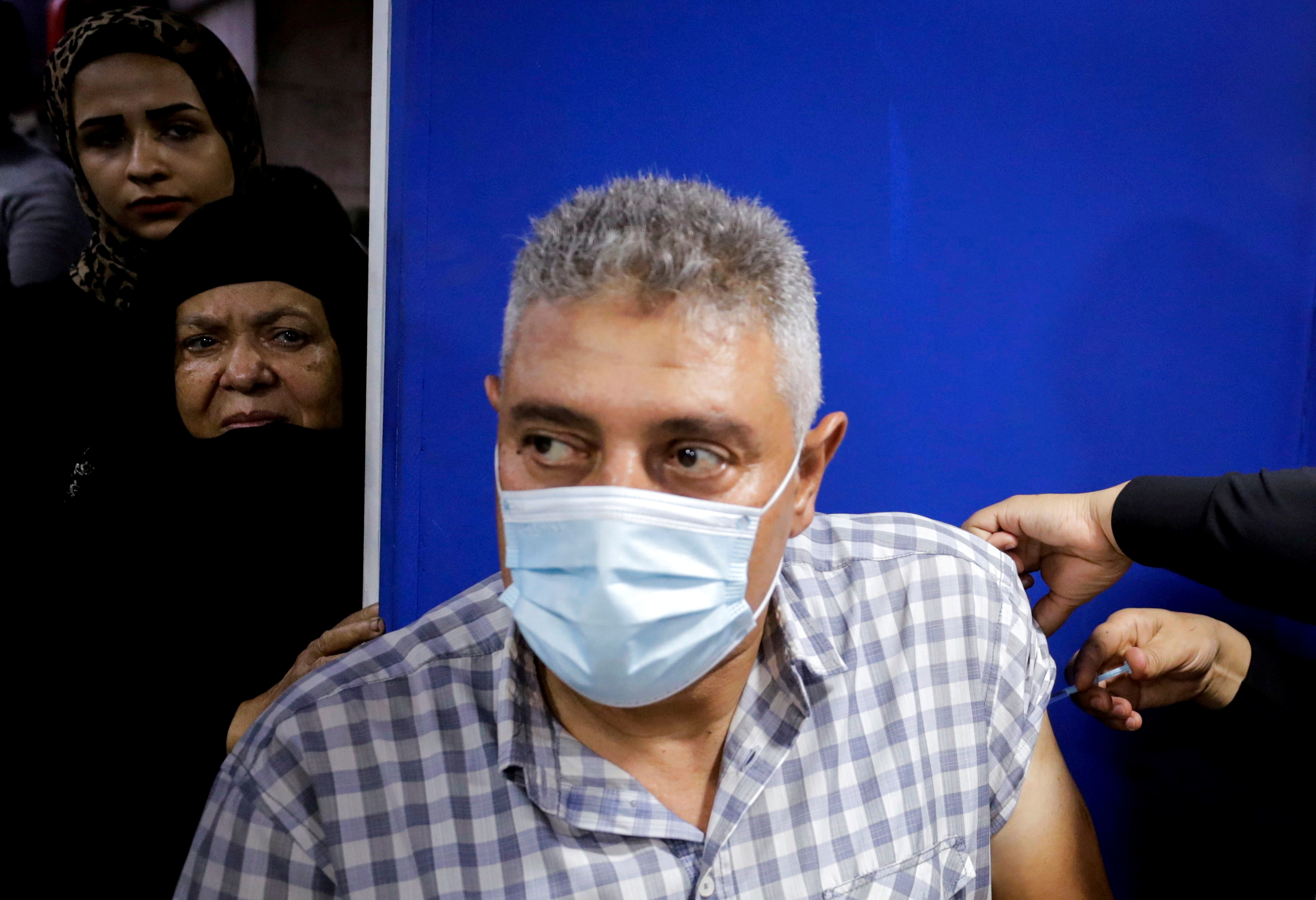 Man receives a dose of the COVID-19 vaccine, in Cairo