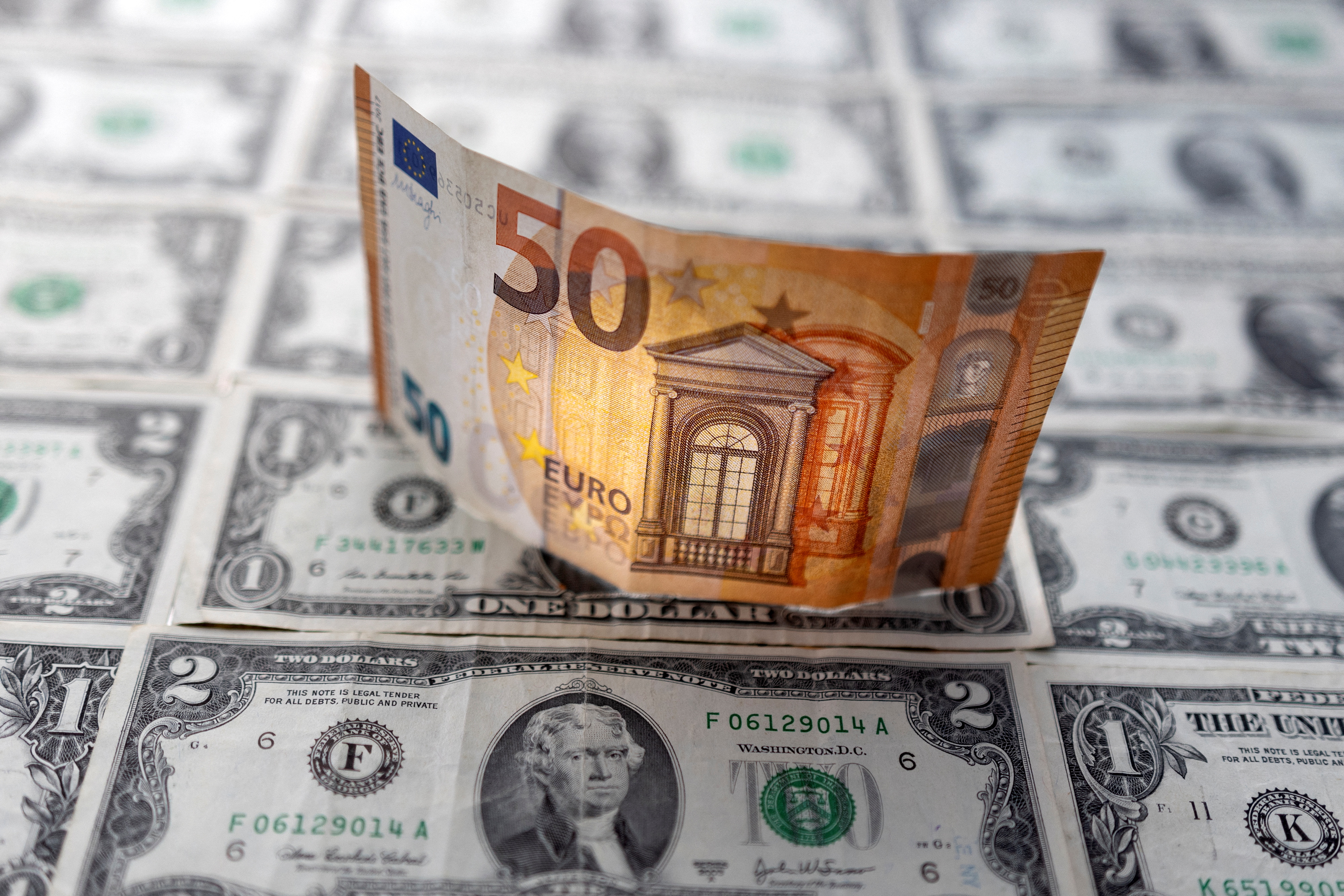  Euro banknote placed on U.S. Dollar banknotes
