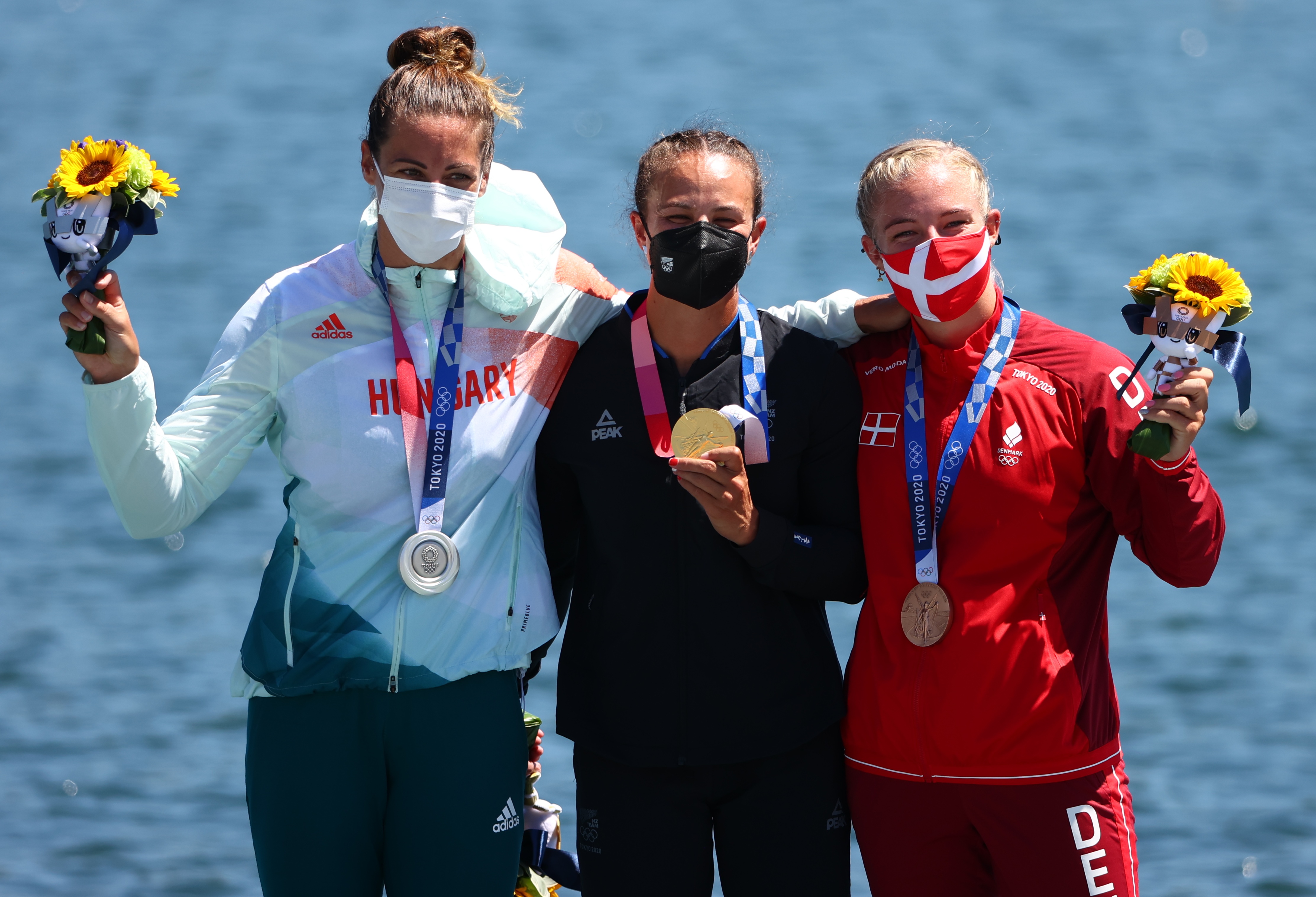 Tokyo 2020 Olympics - Canoe Sprint - Women's K1 500m - Medal Ceremony - Sea Forest Waterway, Tokyo, Japan – August 5, 2021. Gold medallist Lisa Carrington of New Zealand celebrates on the podium with silver medallist, Tamara Csipes of Hungary and bronze medallist, Emma Jorgensen of Denmark REUTERS/Lindsey Wasson