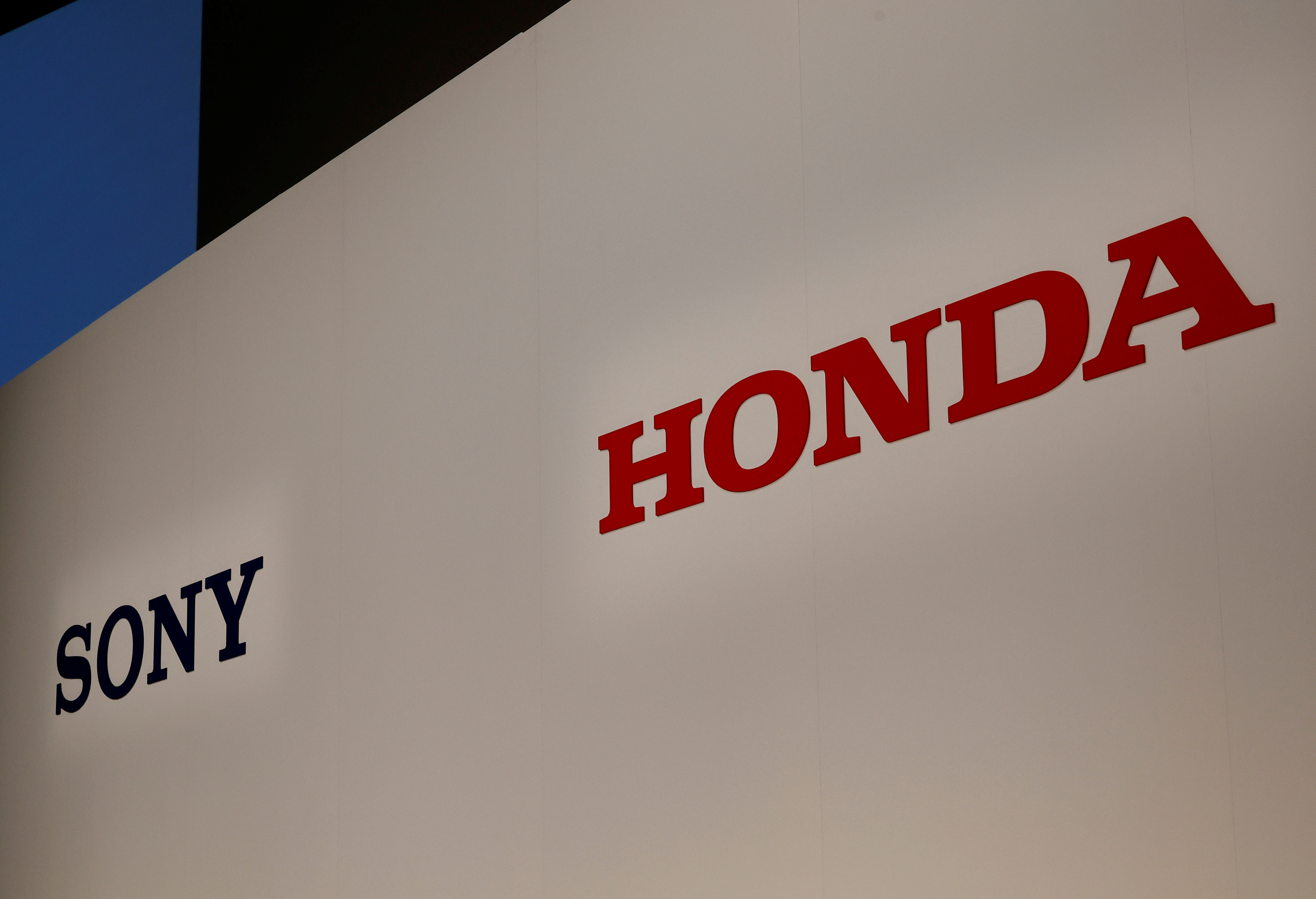 Sony Corp's and Honda Motor's logos are pictured at their joint news conference venue in Tokyo