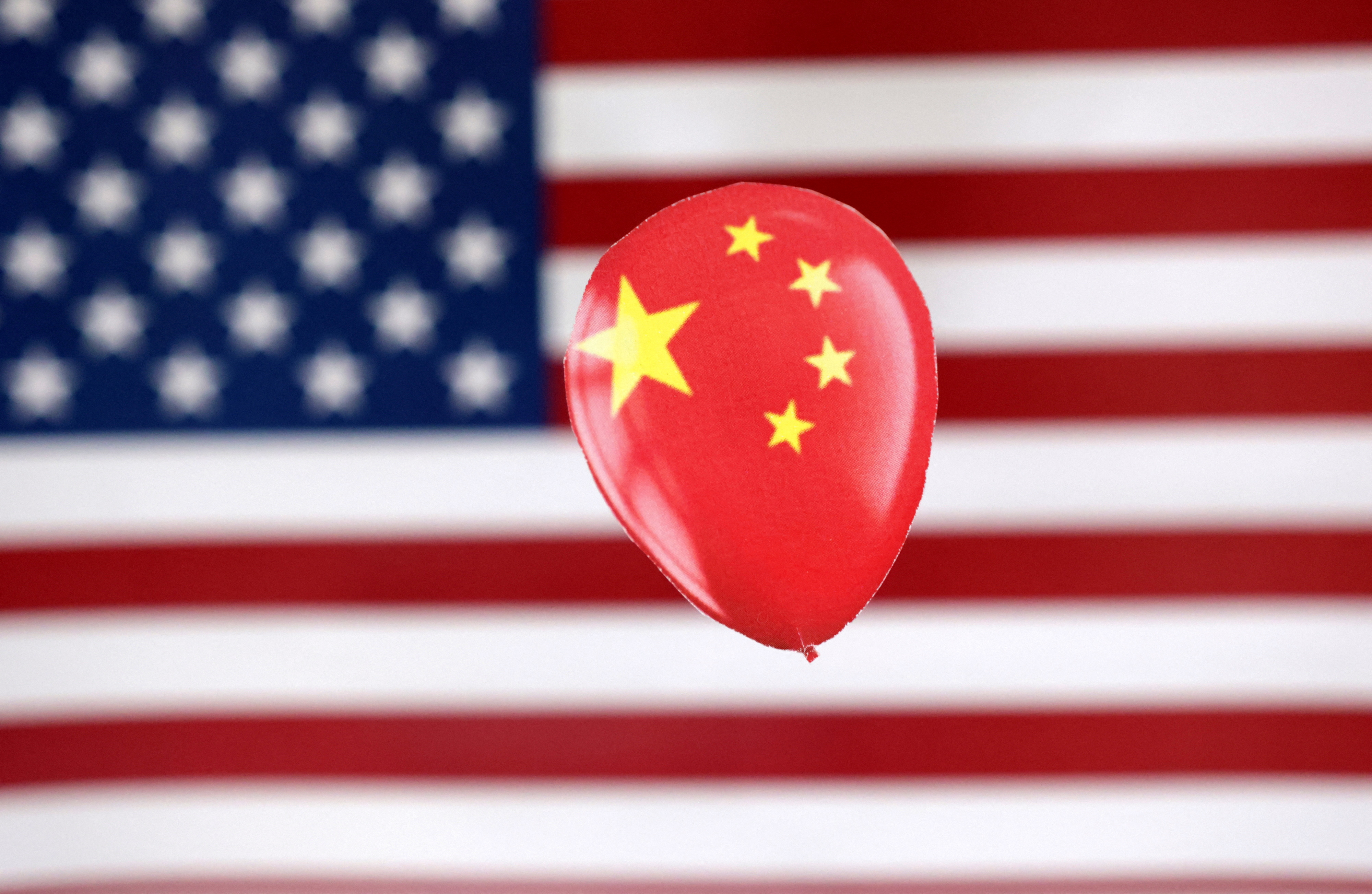 Illustration shows printed balloon with Chinese flag and U.S. flag
