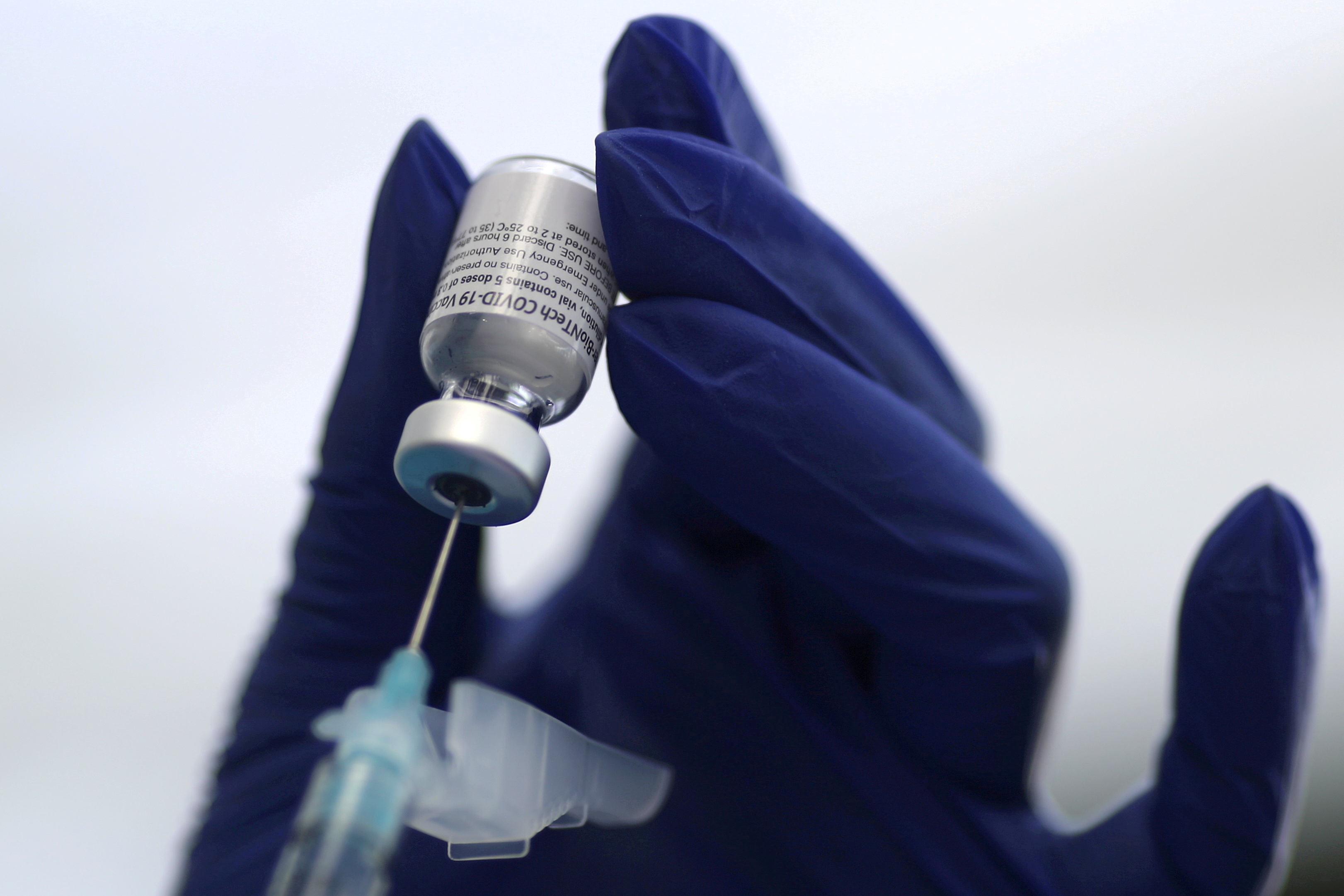 A healthcare worker prepares a Pfizer coronavirus disease (COVID-19) vaccination in Los Angeles