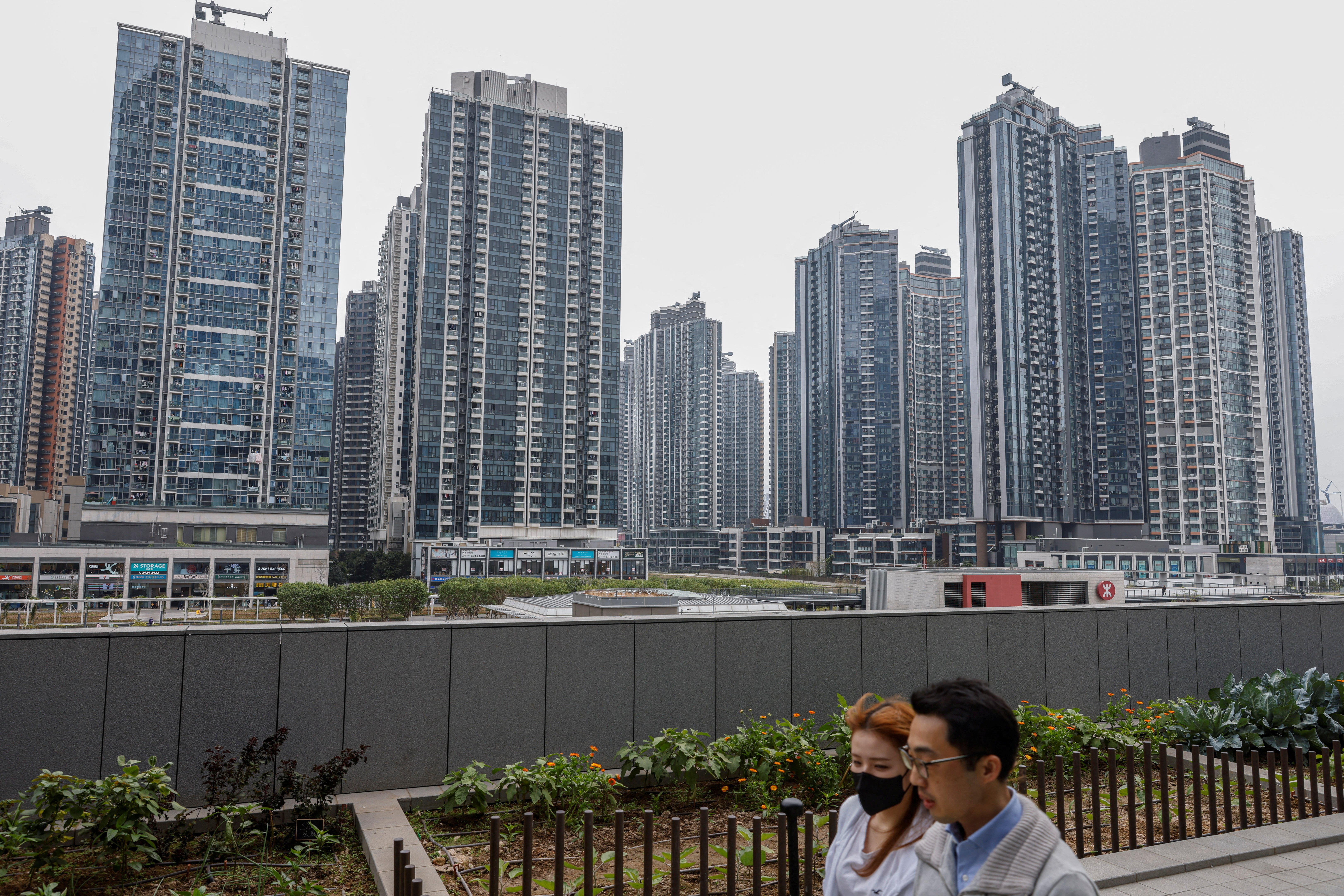 People walk in front of residential buildings, in Hong Kong