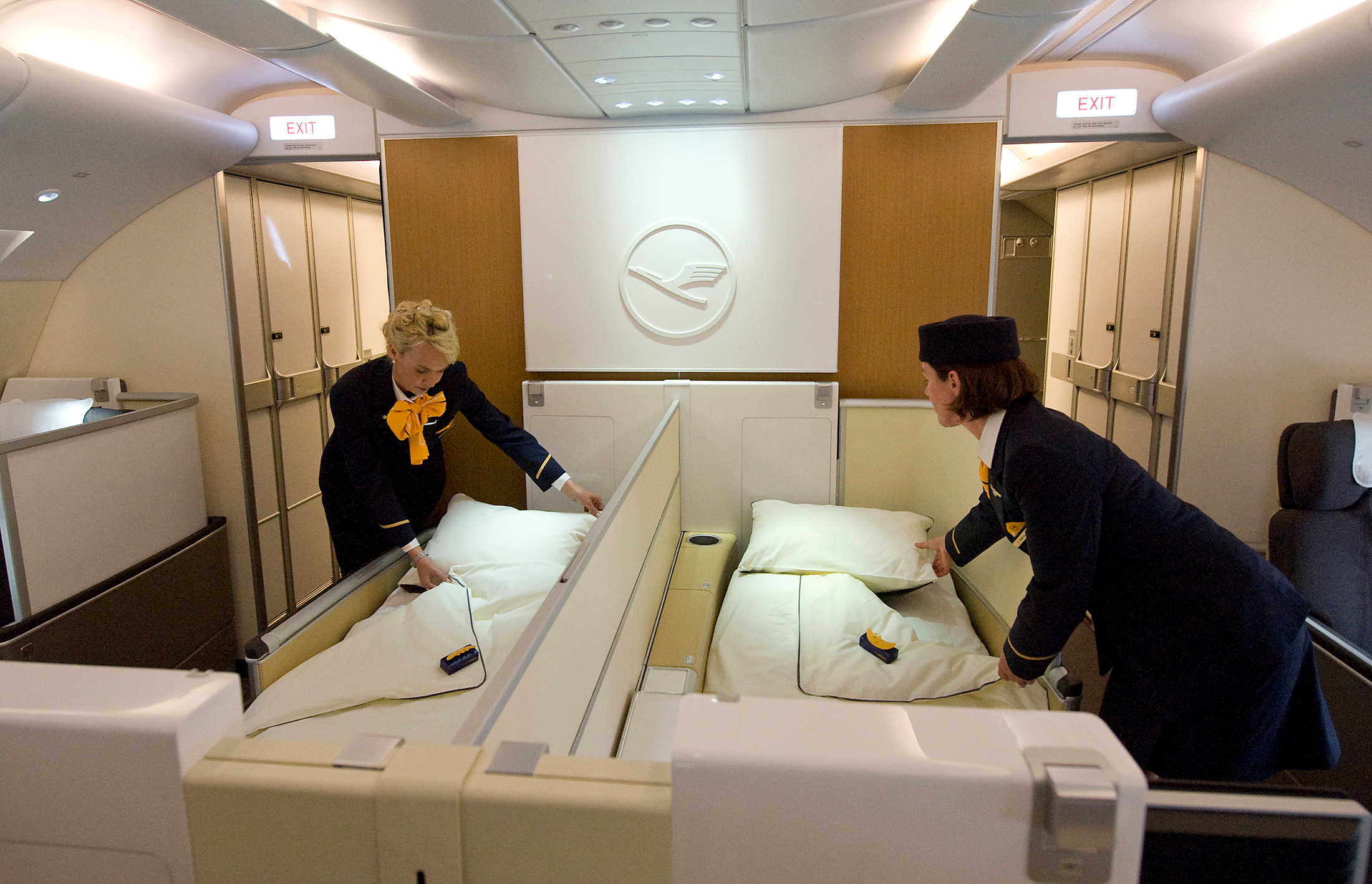Flight attendants pose as they prepare beds of First in new Airbus A380 aircraft for Lufthansa before hand-over ceremony at manufacturer's site in Finkenwerder, near Hamburg