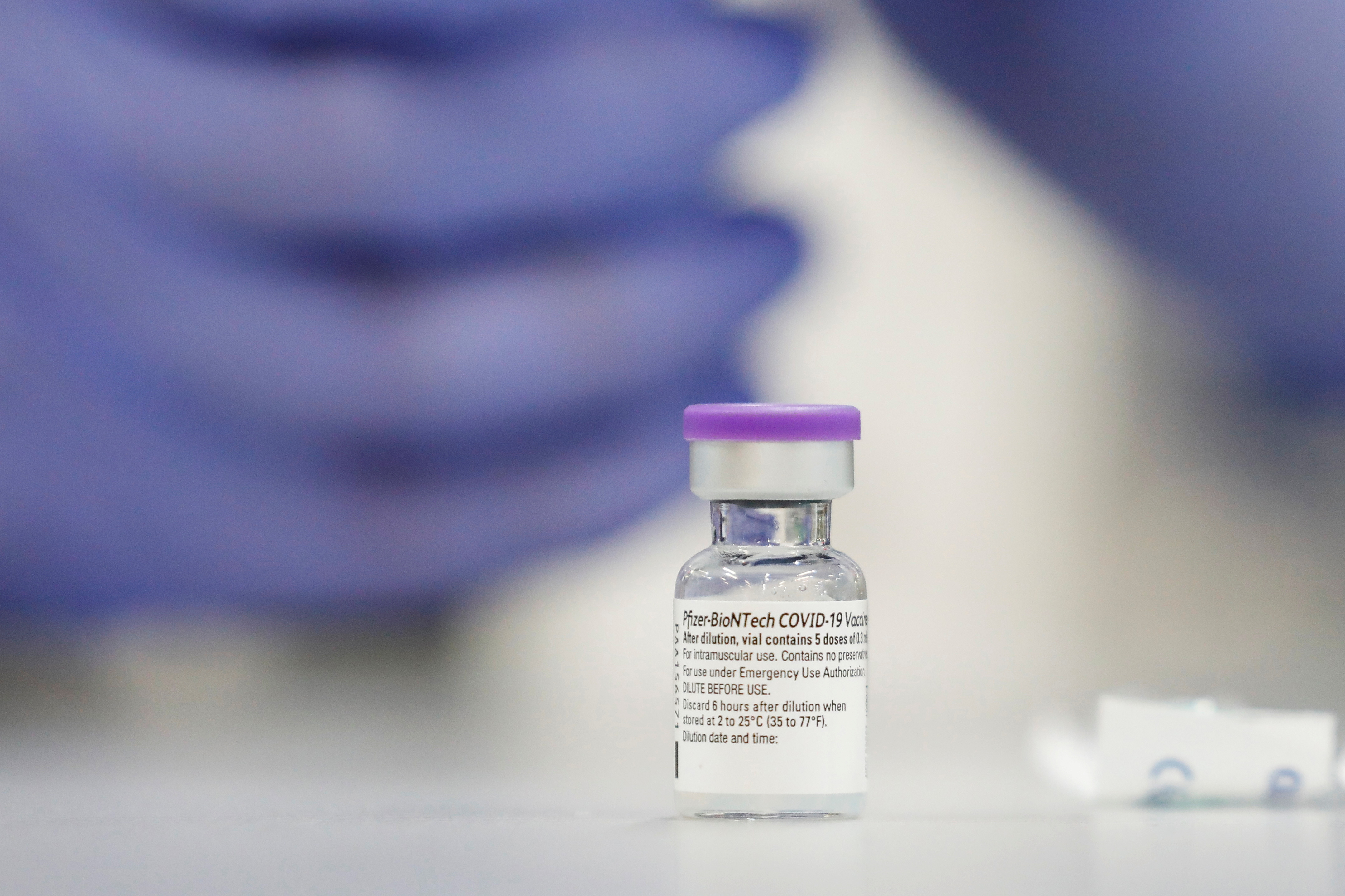 A vial of the Pfizer vaccine against the coronavirus disease (COVID-19) is seen as medical staff are vaccinated at Sheba Medical Center in Ramat Gan, Israel