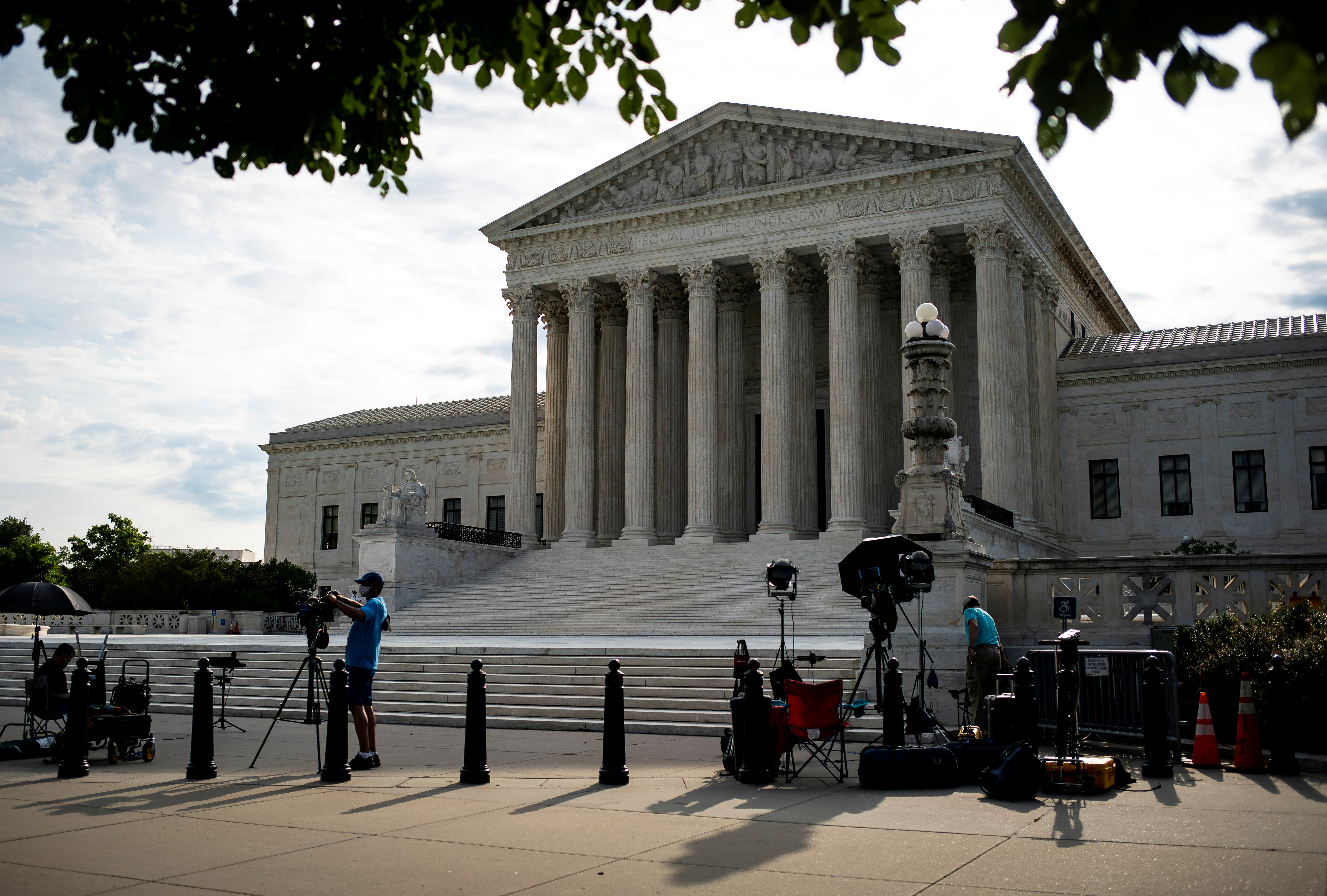 Members of the media set up in front of the U.S. Supreme Court building in Washington
