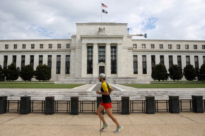 A jogger runs past the Federal Reserve building in Washington, DC