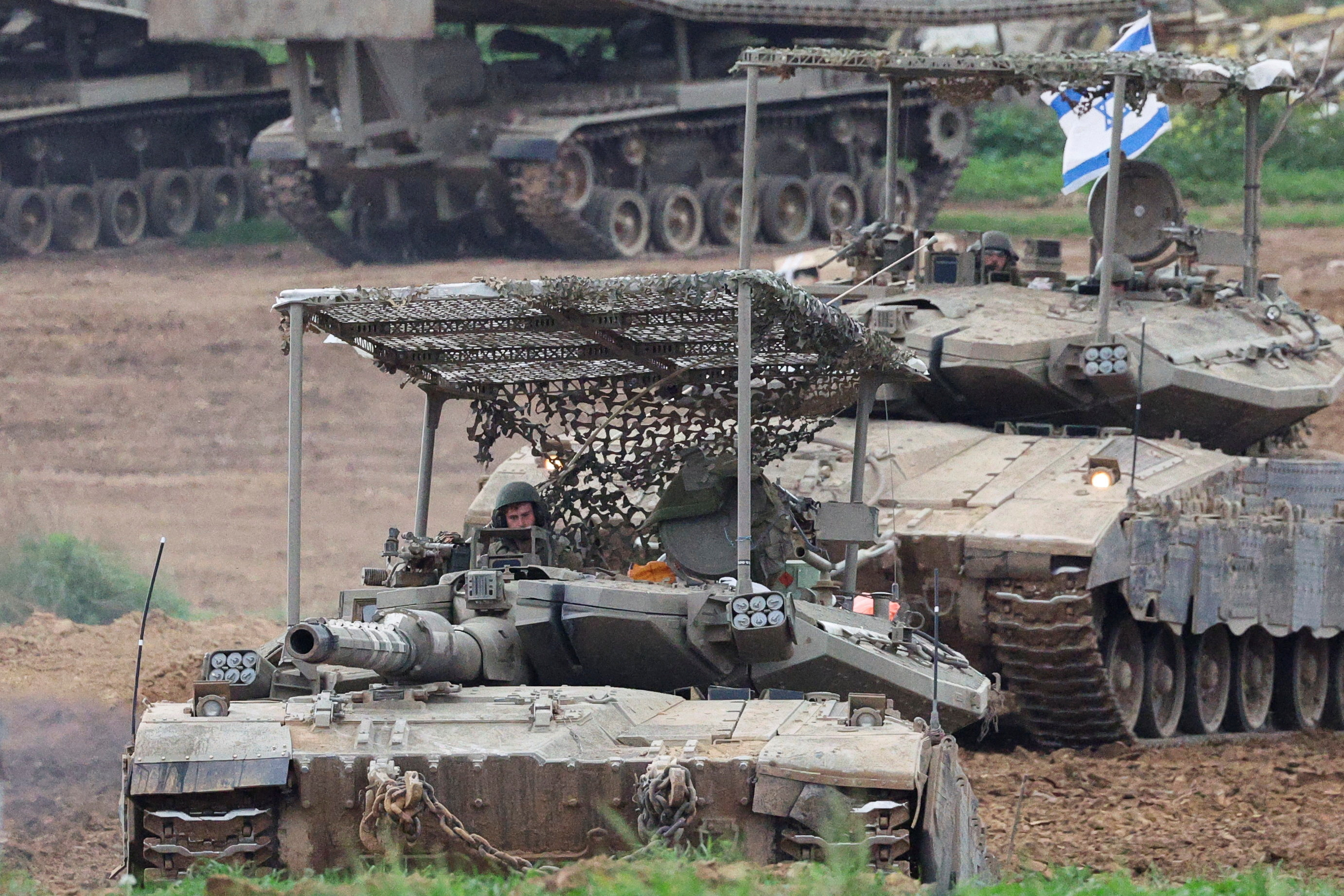 Israeli army tanks manoeuvre near the Israel-Gaza border