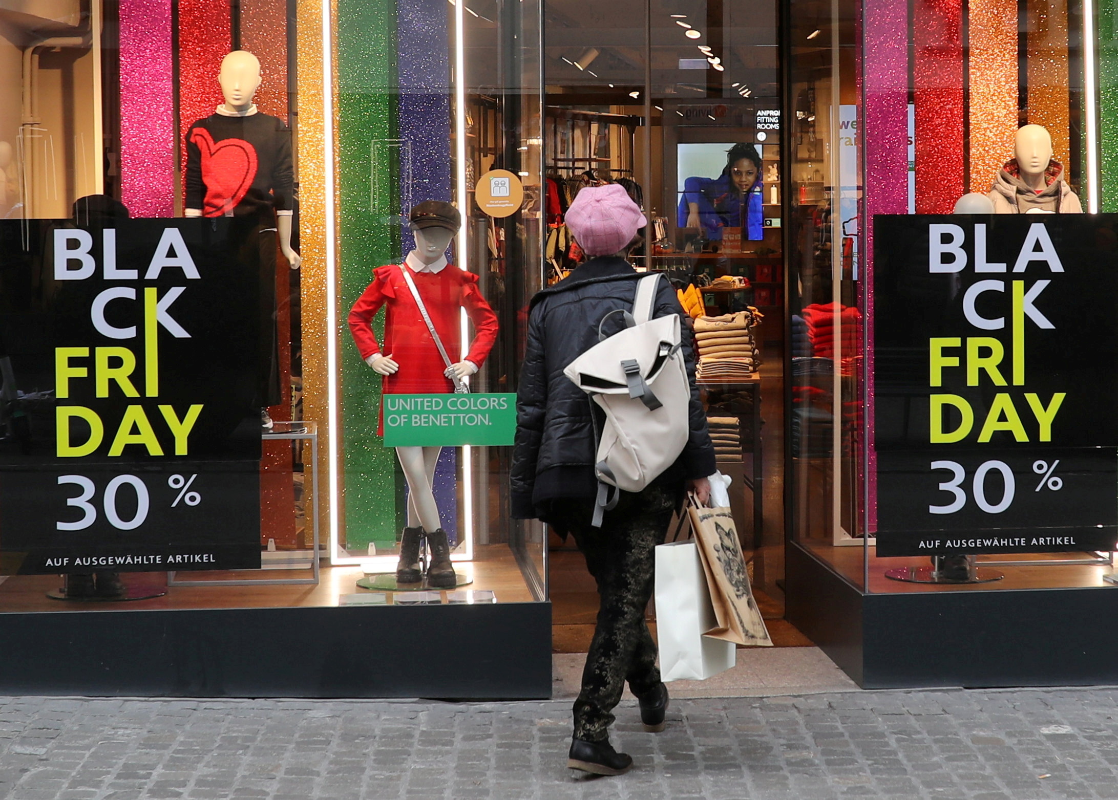 Posters offering special discount on Black Friday sales are seen in front of a United Colors of Benetton kid's fashion store in Zurich