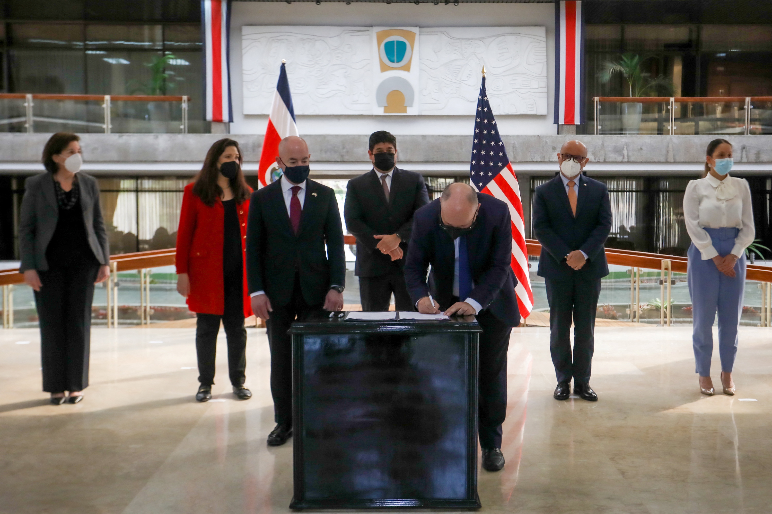 U.S. Homeland Security Secretary Mayorkas and Costa Rica's President Carlos Alvarado look on as Costa Rica's Minister of Public Security Soto signs bilateral documents in San Jose