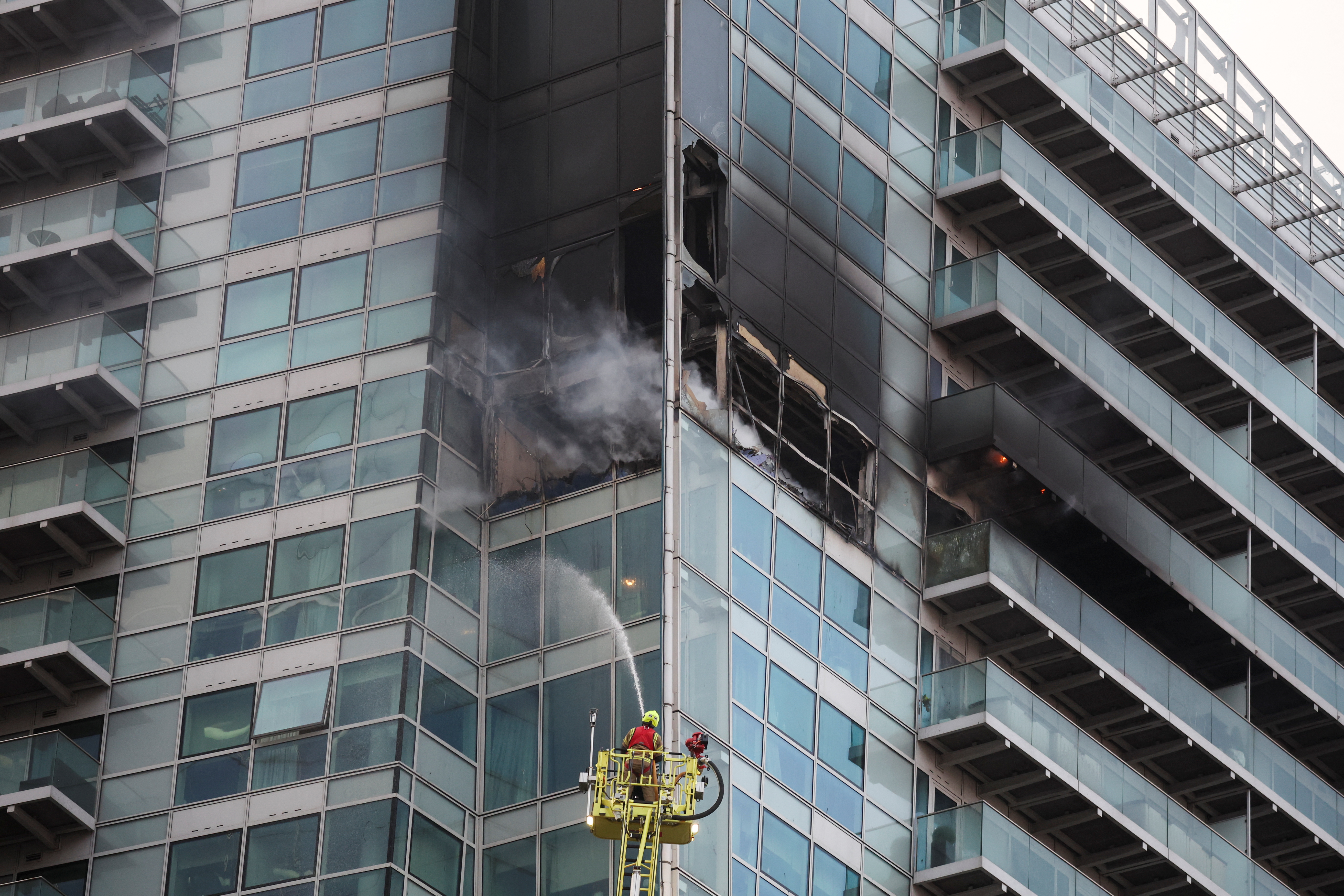 Firefighters extinguish a fire at a building in East London