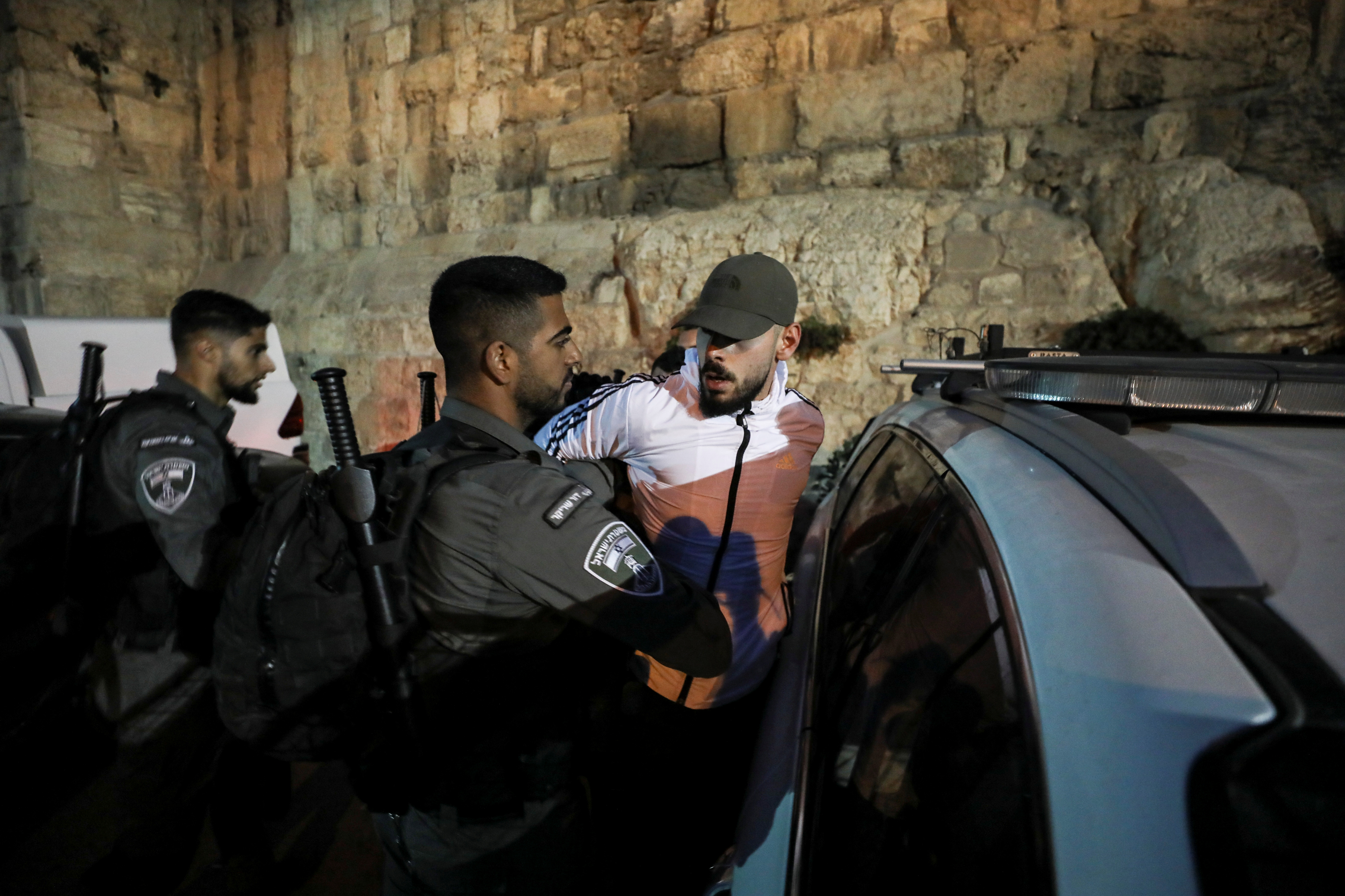 Israeli border police detain a Palestinian man during a protest against Israel’s building of a Jerusalem park which they say encroaches on a centuries-old Muslim graveyard near Old City wall, in Jerusalem
