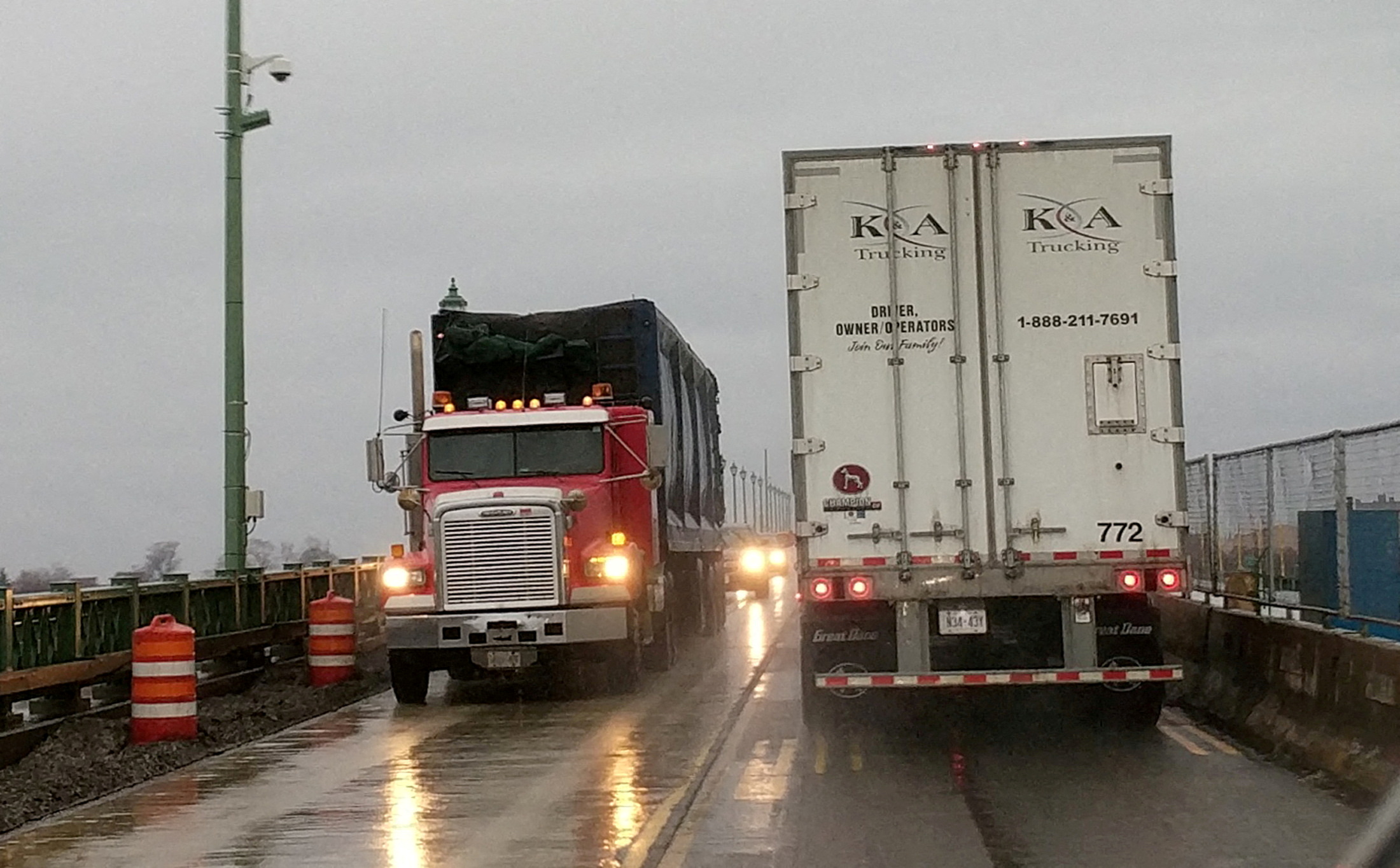 Transport trucks cross paths on the Peace Bridge at the Canada U.S. border in Buffalo