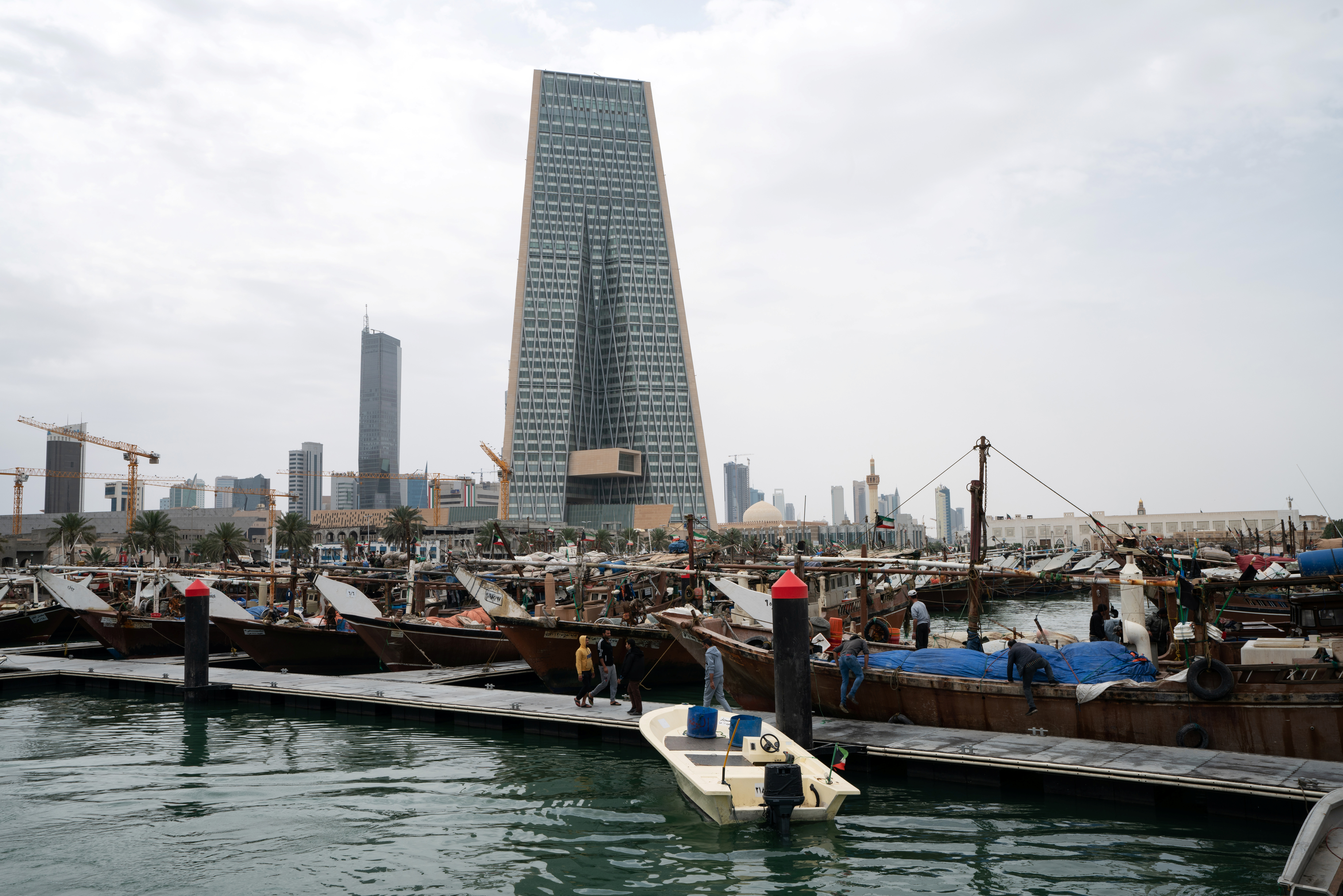 The Kuwait Central Bank towers over the traditional Dhow harbor in Kuwait City