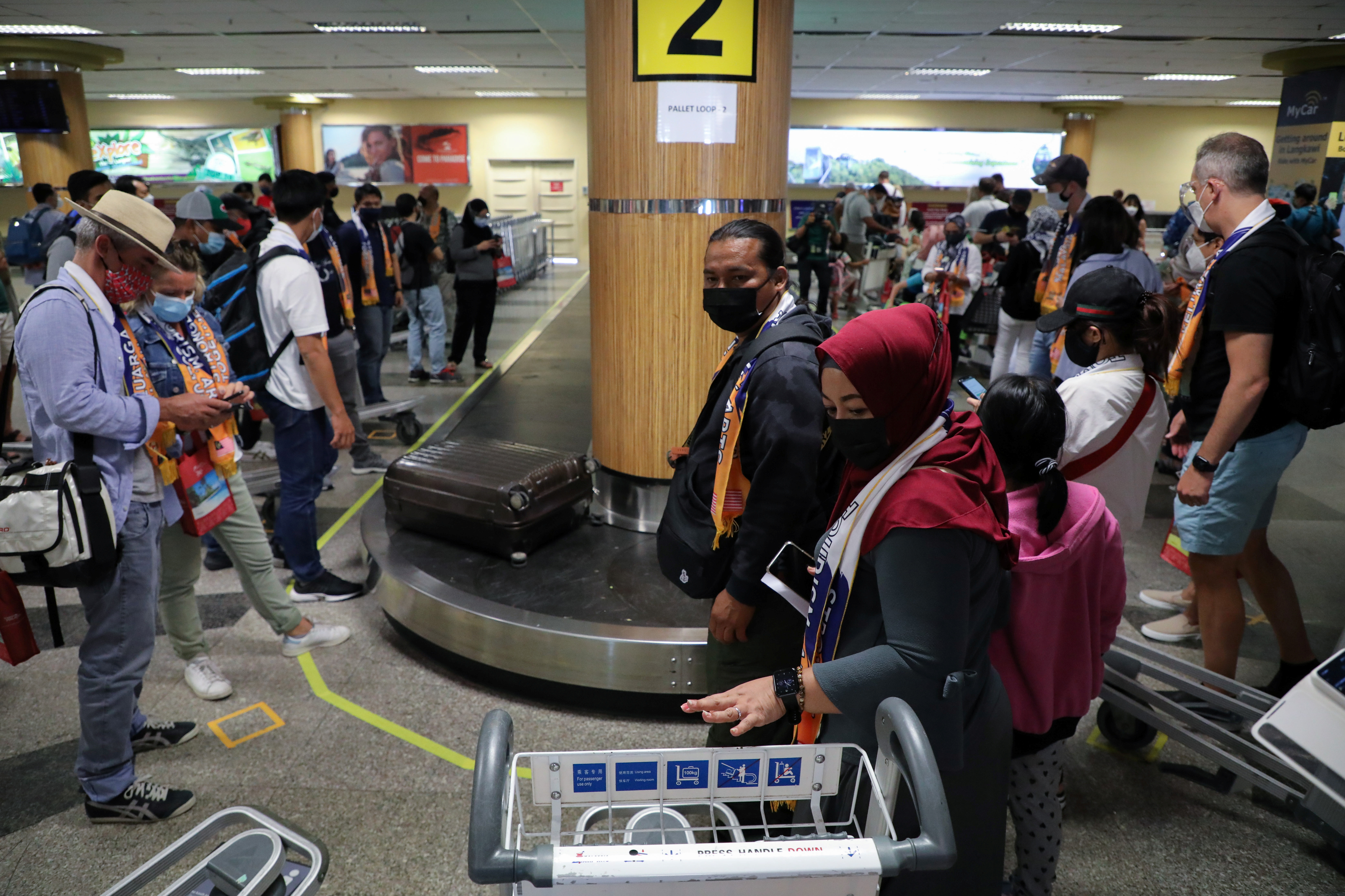Tourists wait for their luggage at the arrival hall, as Langkawi reopens to domestic tourists, amid the coronavirus disease (COVID-19) pandemic, in Malaysia September 16, 2021. REUTERS/Lim Huey Teng