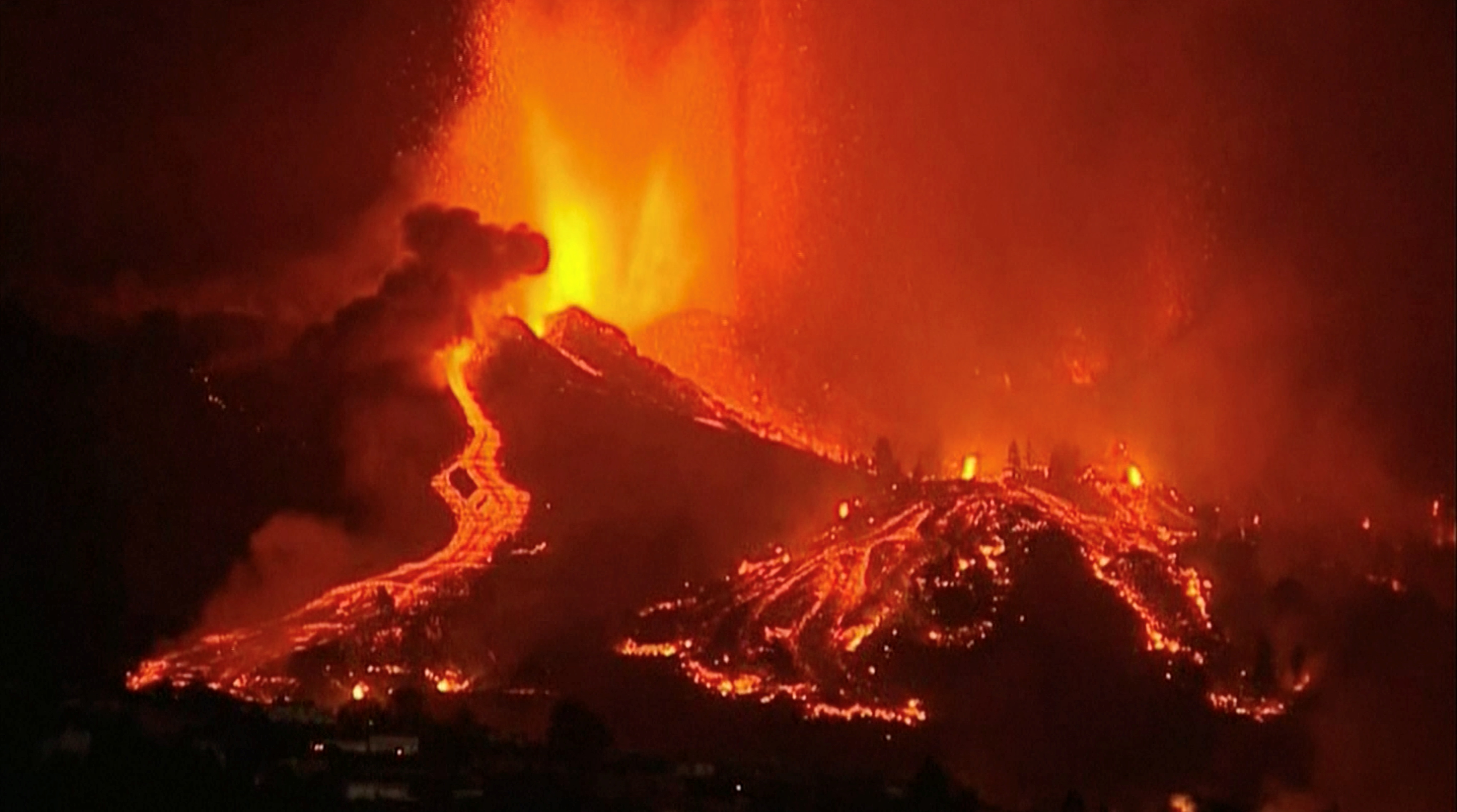 Lava pours out of a volcano in the Cumbre Vieja national park at El Paso, on the Canary Island of La Palma, September 19, 2021, in this screen grab taken from a video. FORTA/Handout via REUTERS  