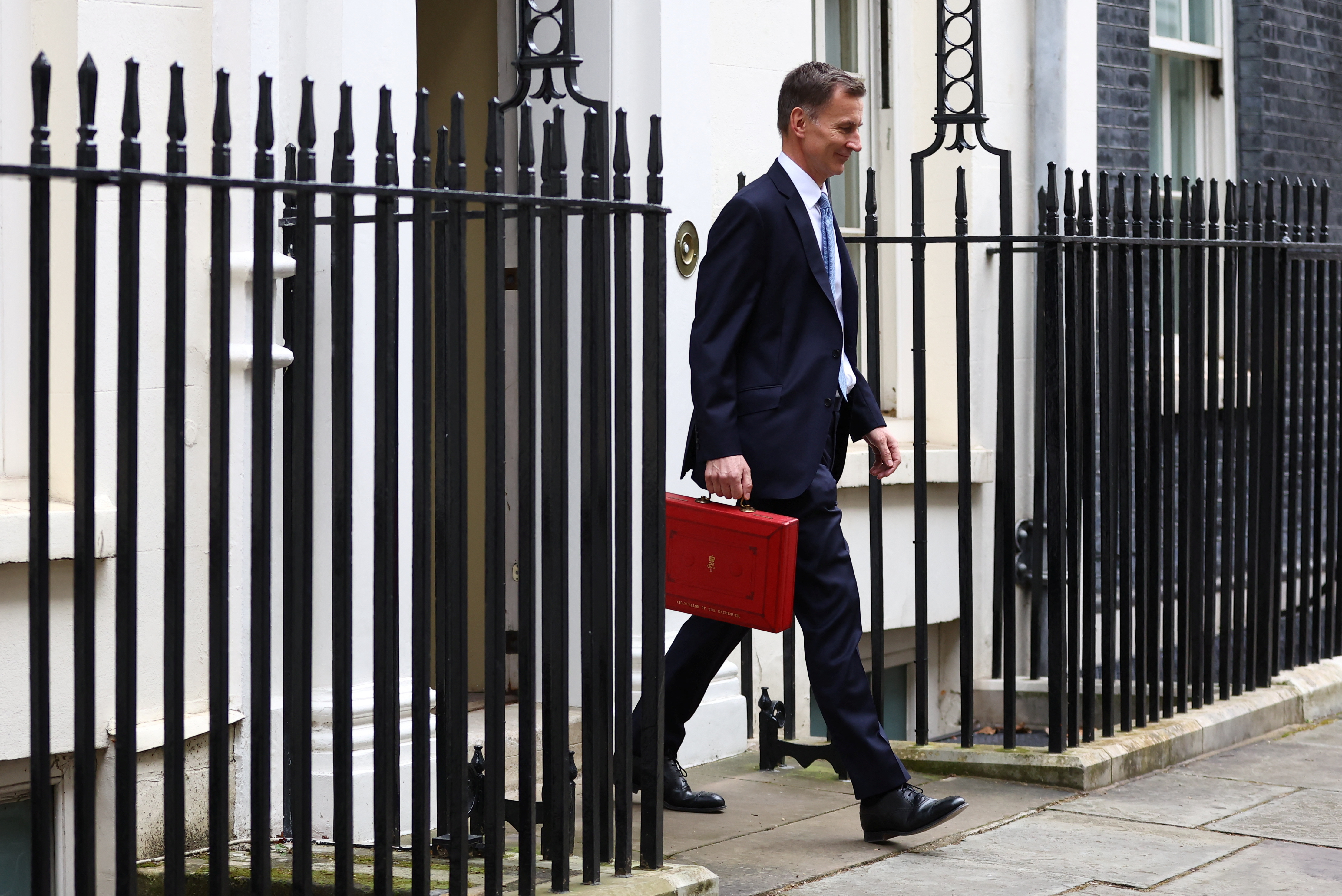 Chancellor of the Exchequer Hunt holds the budget box outside Downing Street in London