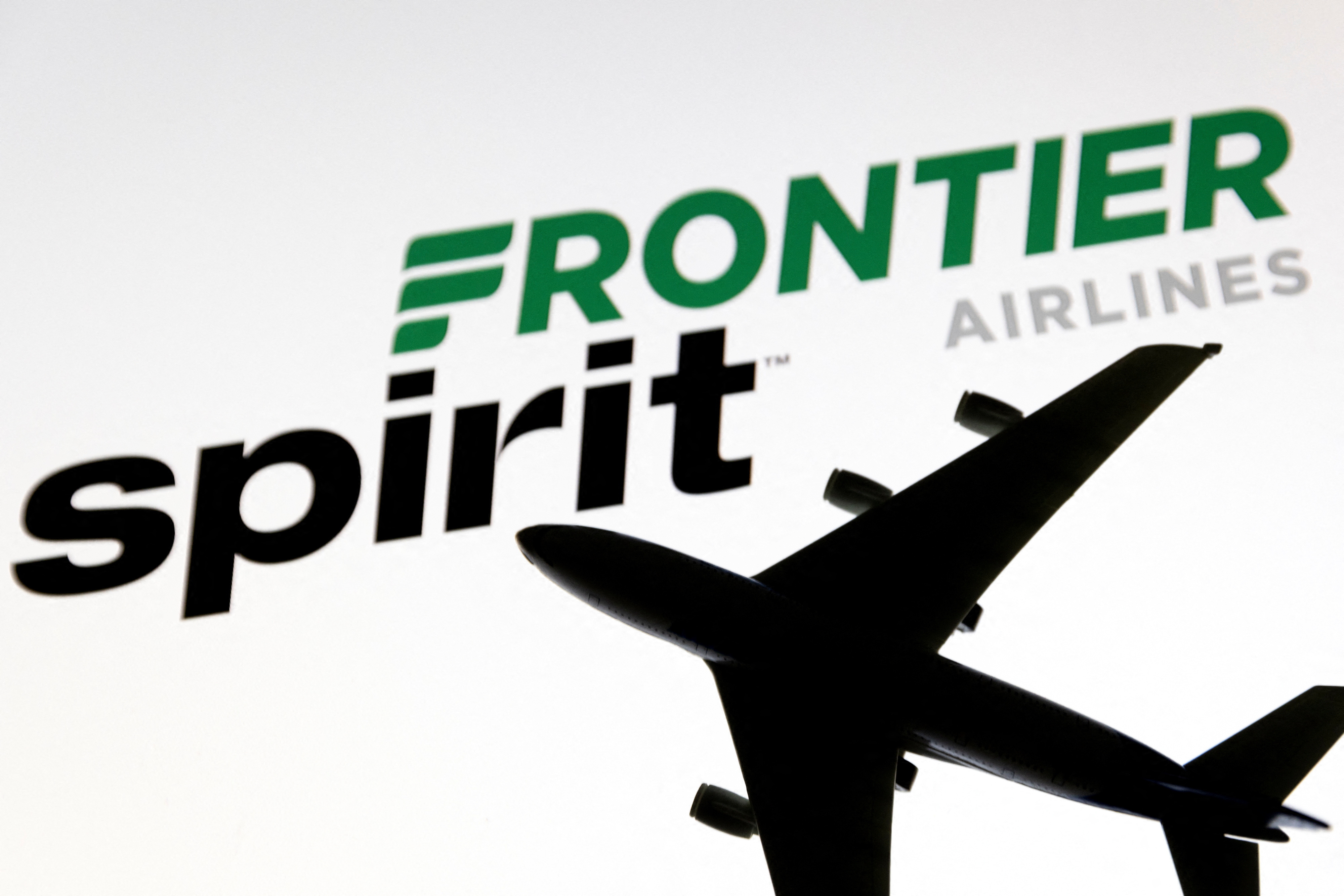 Illustration shows Spirit and Frontier Airlines logos