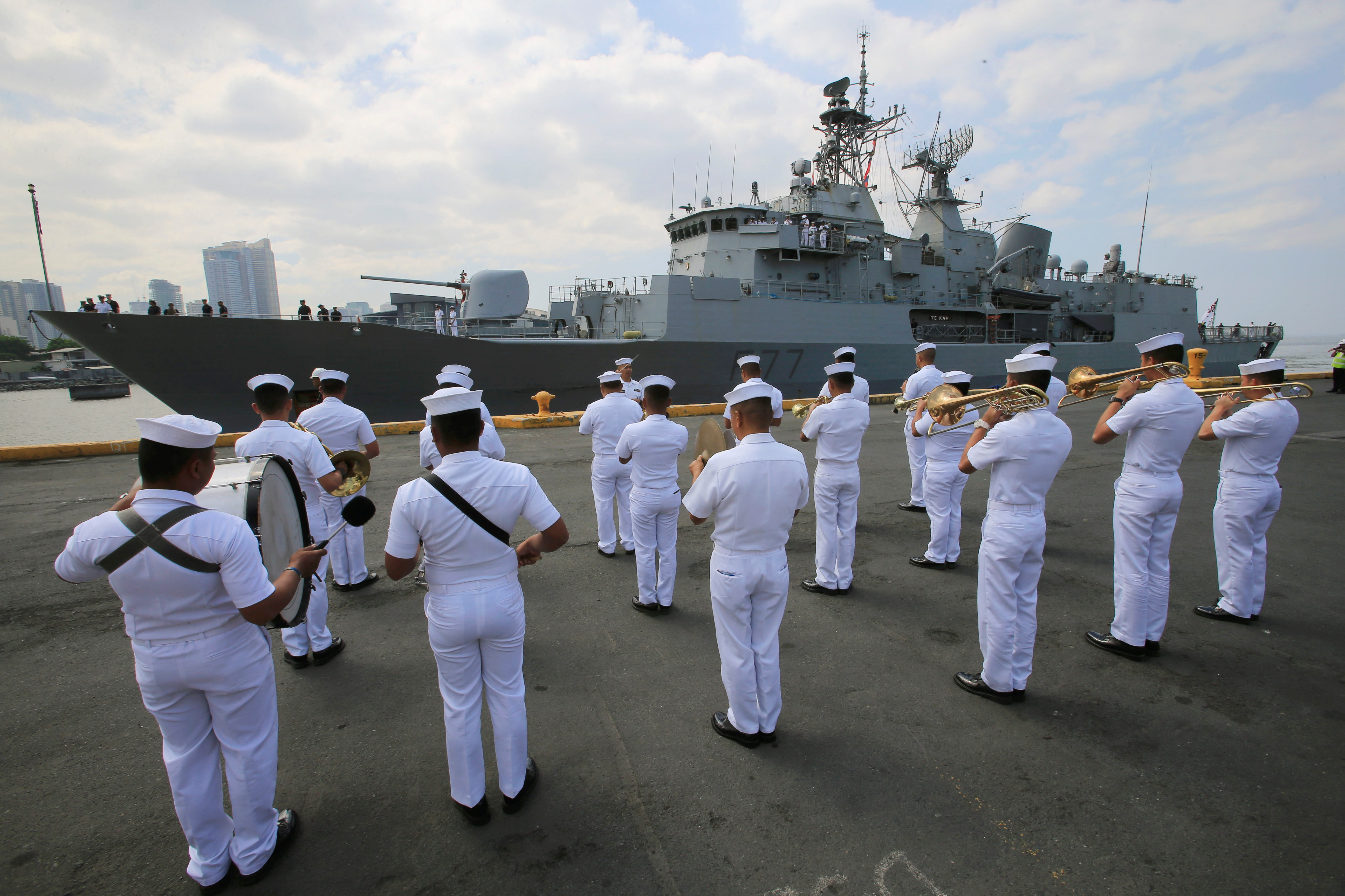 Philippine Navy band plays music to welcome the Royal New Zealand Navy frigate HMNZS Te Kaha (F77), upon arrival at the South Harbor, for a four-day goodwill visit in metro Manila