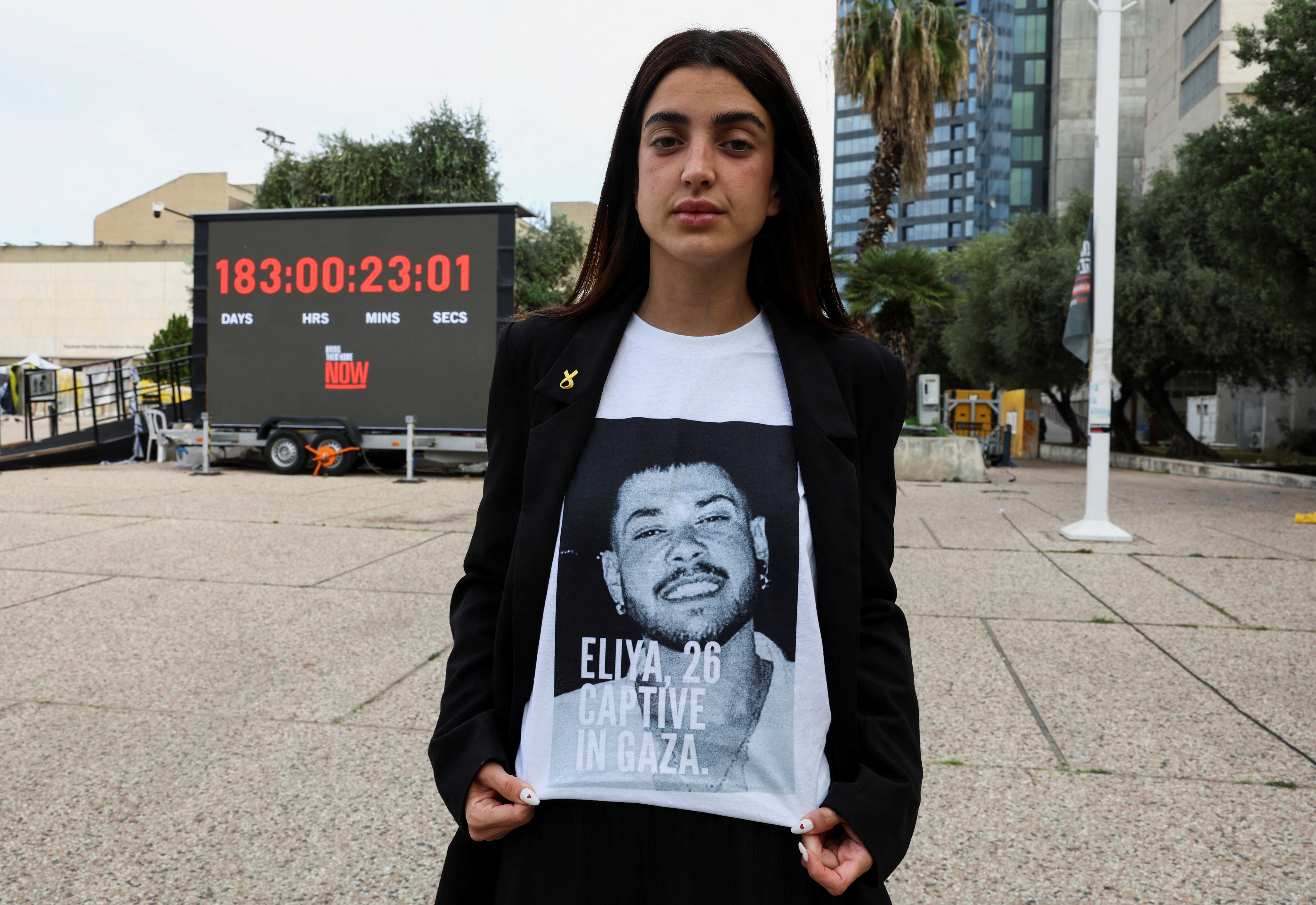 Ziv Abud, the girlfriend of hostage Eliya Cohen, who was kidnapped during the October 7 attack on Israel by Palestinian Islamist group Hamas from Gaza, shows her t-shirt with a picture of Eliya during an interview with Reuters, in Tel Aviv