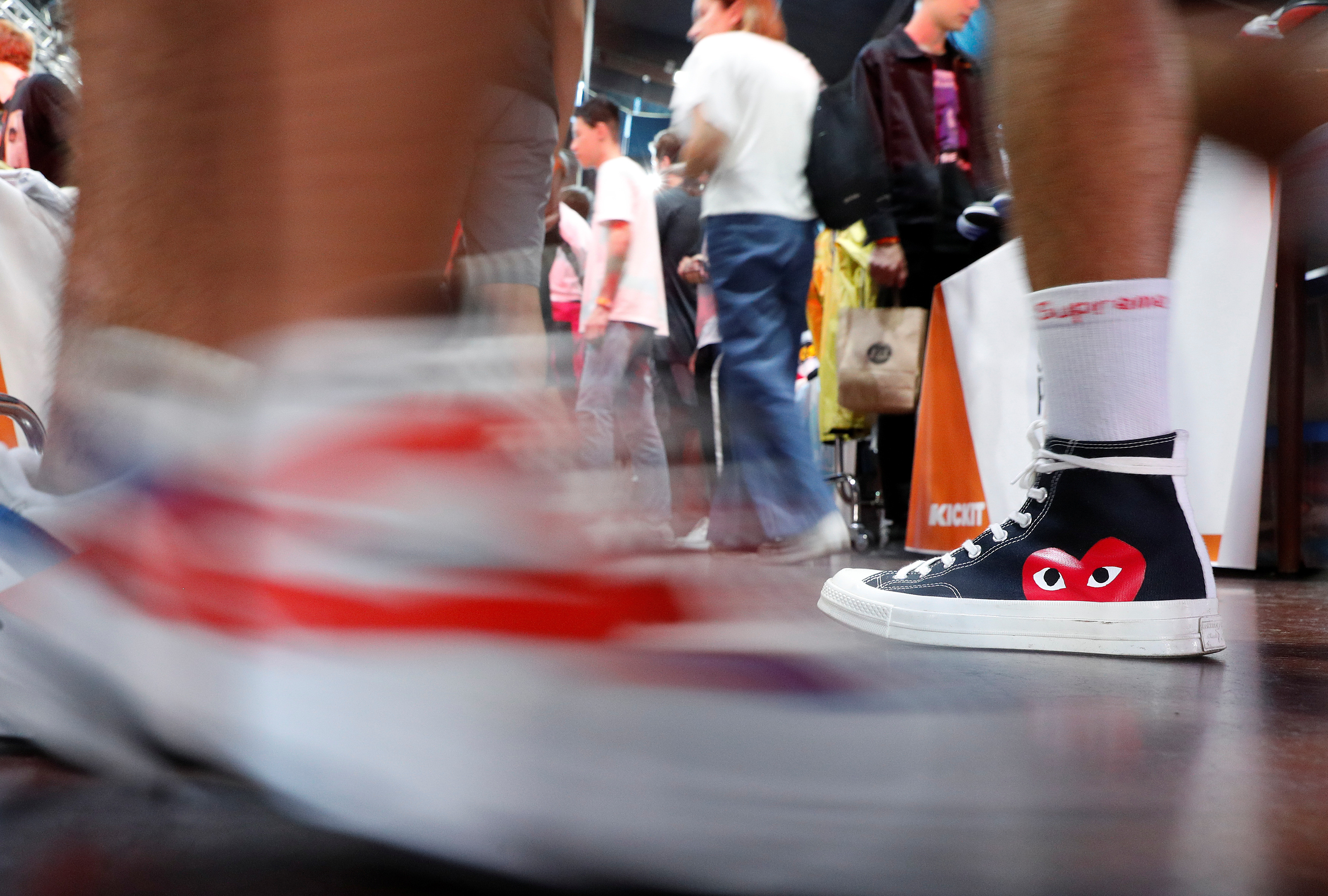 A man walks wearing a limited edition of Converse Chuck Taylor All Star Õ70 sneakers at the KICKIT Sneaker e Streetwear Market in Rome