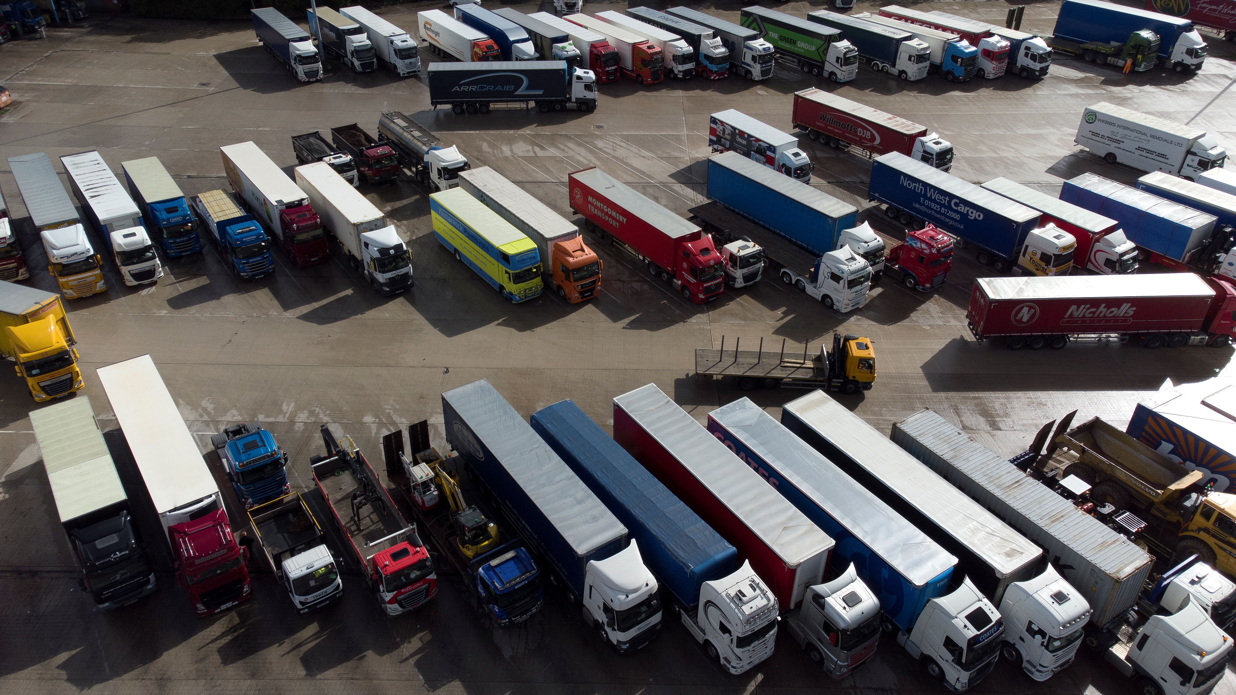 Lorries are seen at Lymm Services, Lymm, Britain, September 29, 2021. Picture taken with a drone. REUTERS/Jason Cairnduff