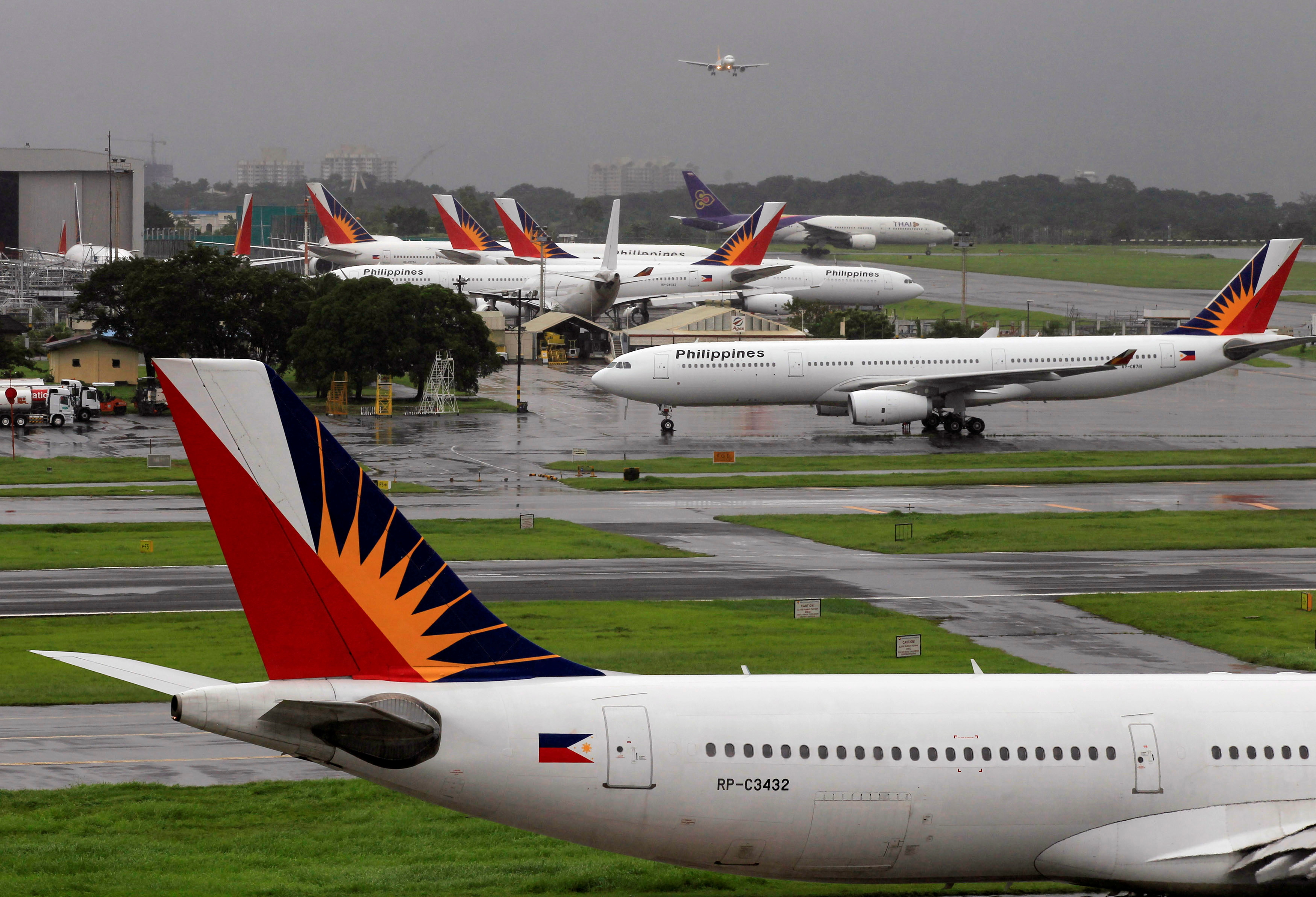 Philippine Airlines planes are seen parked on tarmac in Manila International Airport in Pasay city, metro Manila