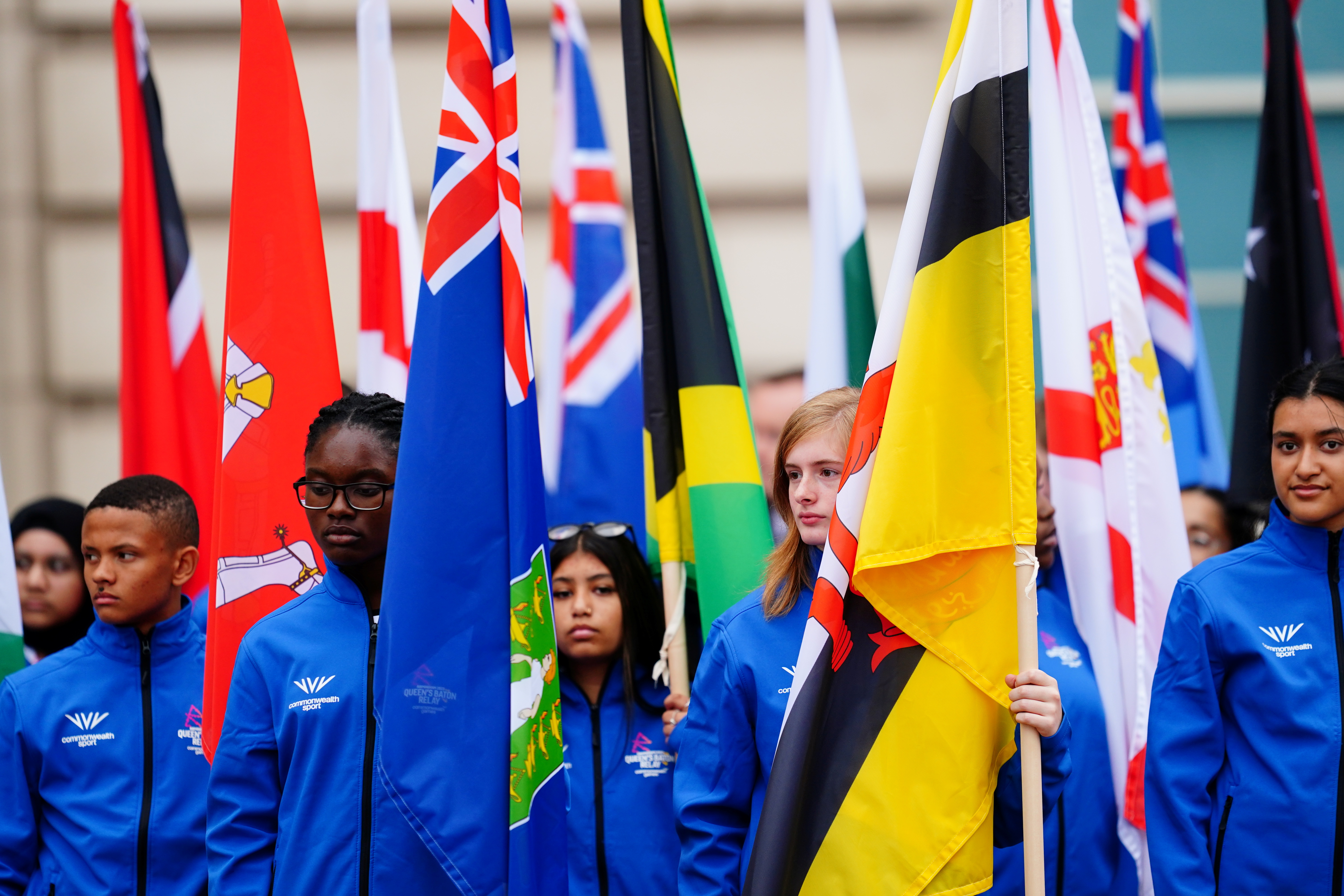 People carry the flags of the Commonwealth countries at the launch of the Commonwealth Games baton relay, outside Buckingham Palace in London, Britain October 7, 2021. Victoria Jones/Pool via REUTERS