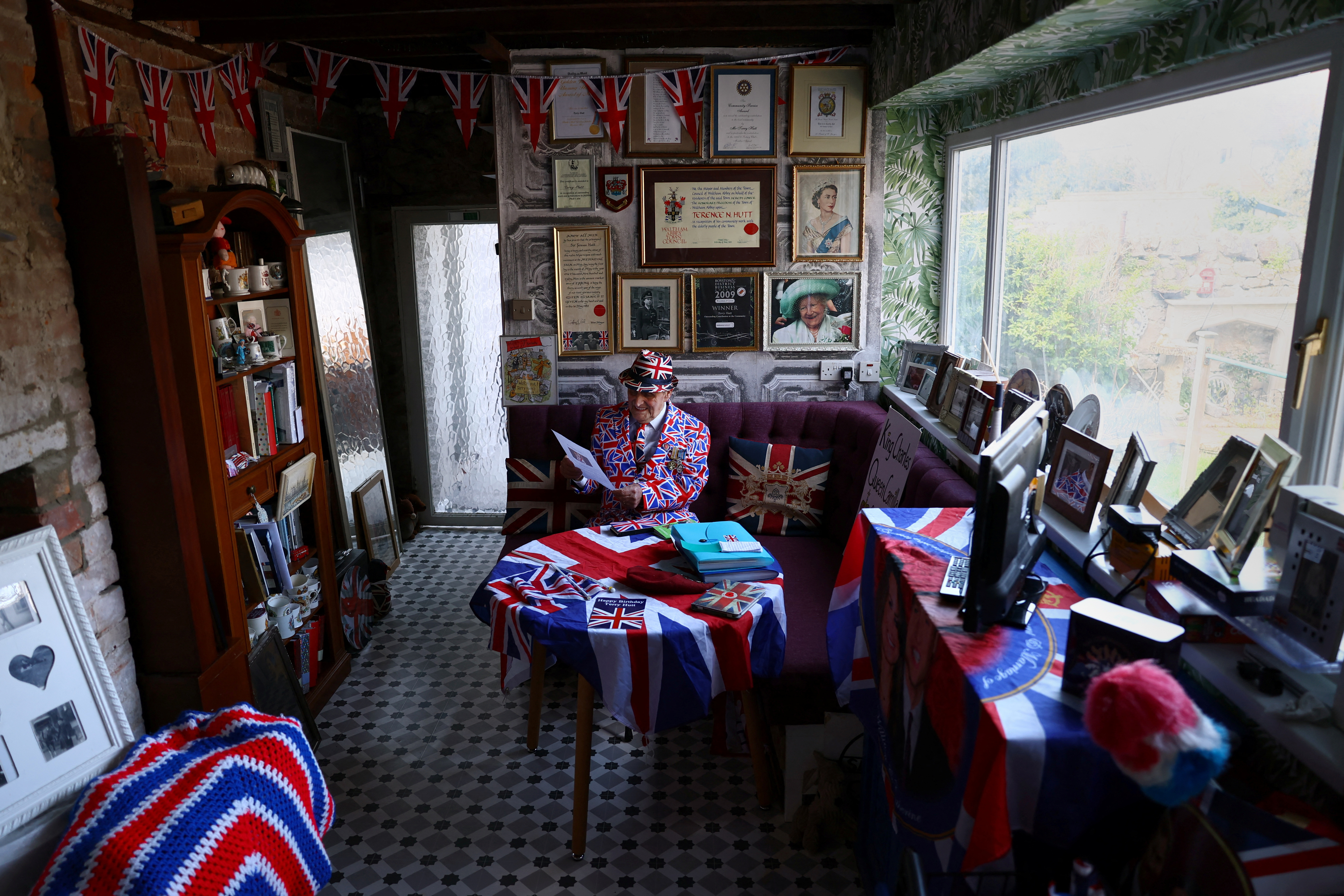 Terry Hutt a life long royals fan sits surrounded by royal memorabilia at his home in Weston-super-Mare