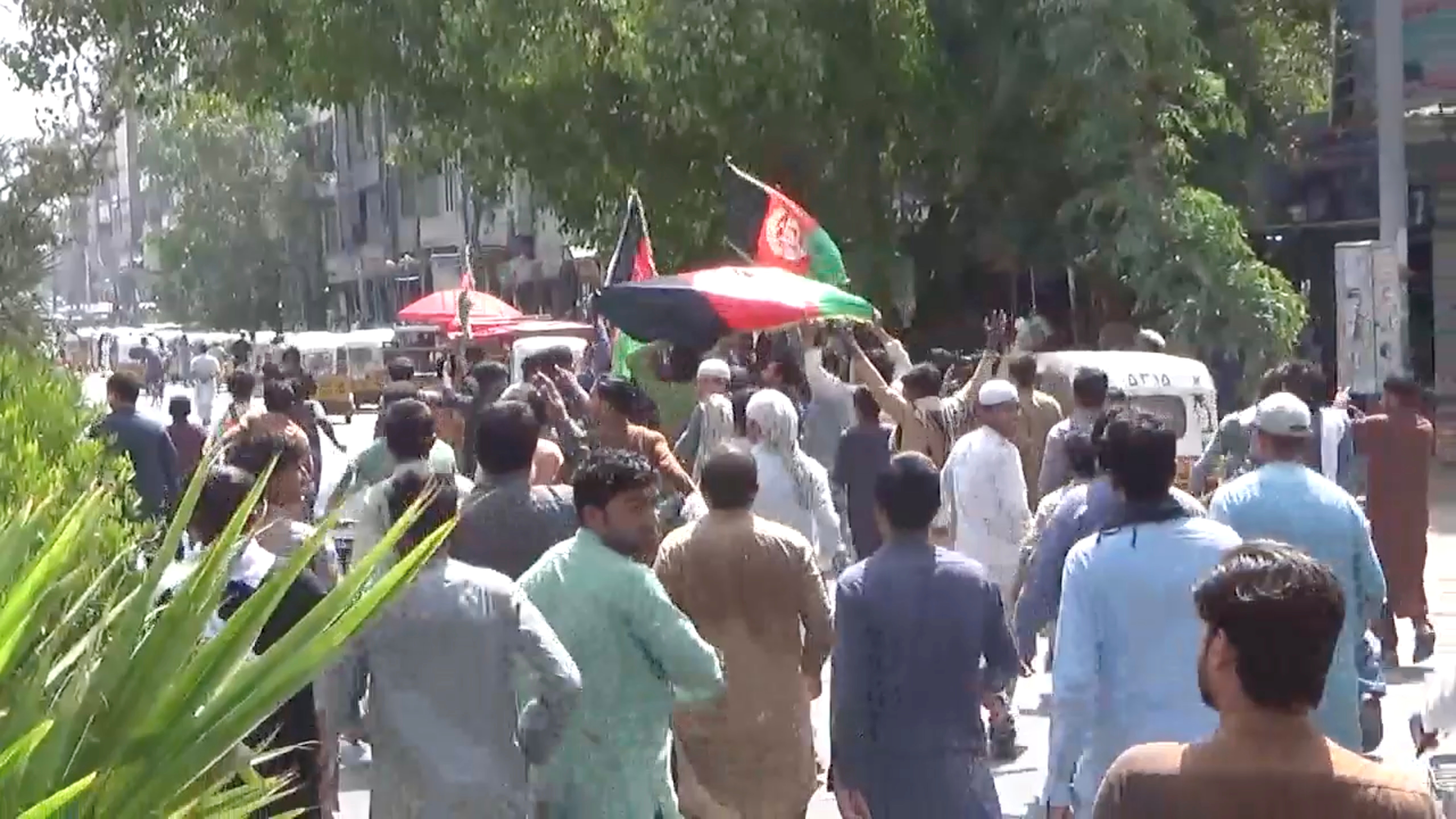 People carry Afghan flags as they take part in an anti-Taliban protest in Jalalabad, Afghanistan August 18, 2021 in this screen grab taken from a video. Pajhwok Afghan News/Handout via REUTERS 