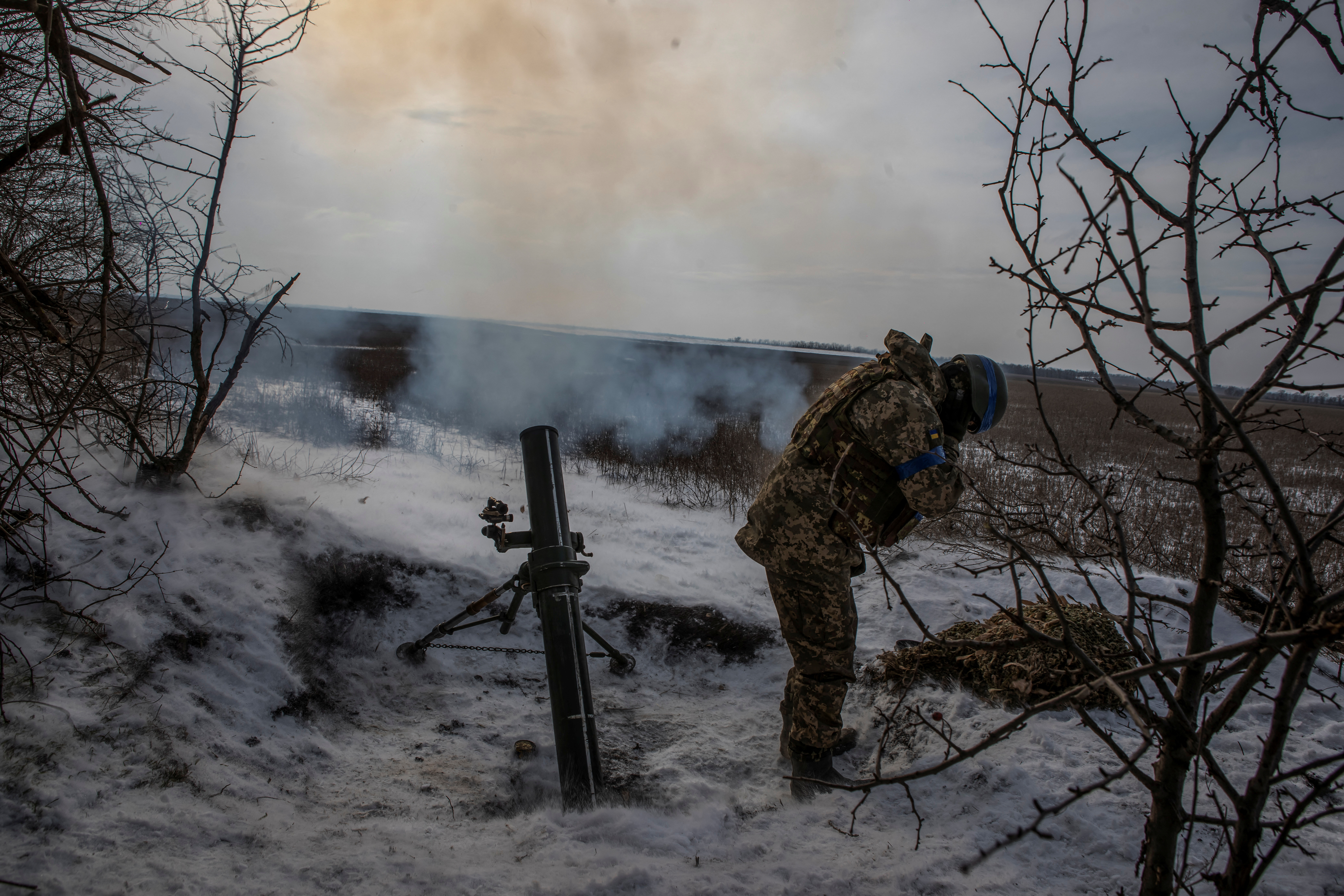 Ukrainian service member fires a mortar towards Russian troops in frontline near the Vuhledar town