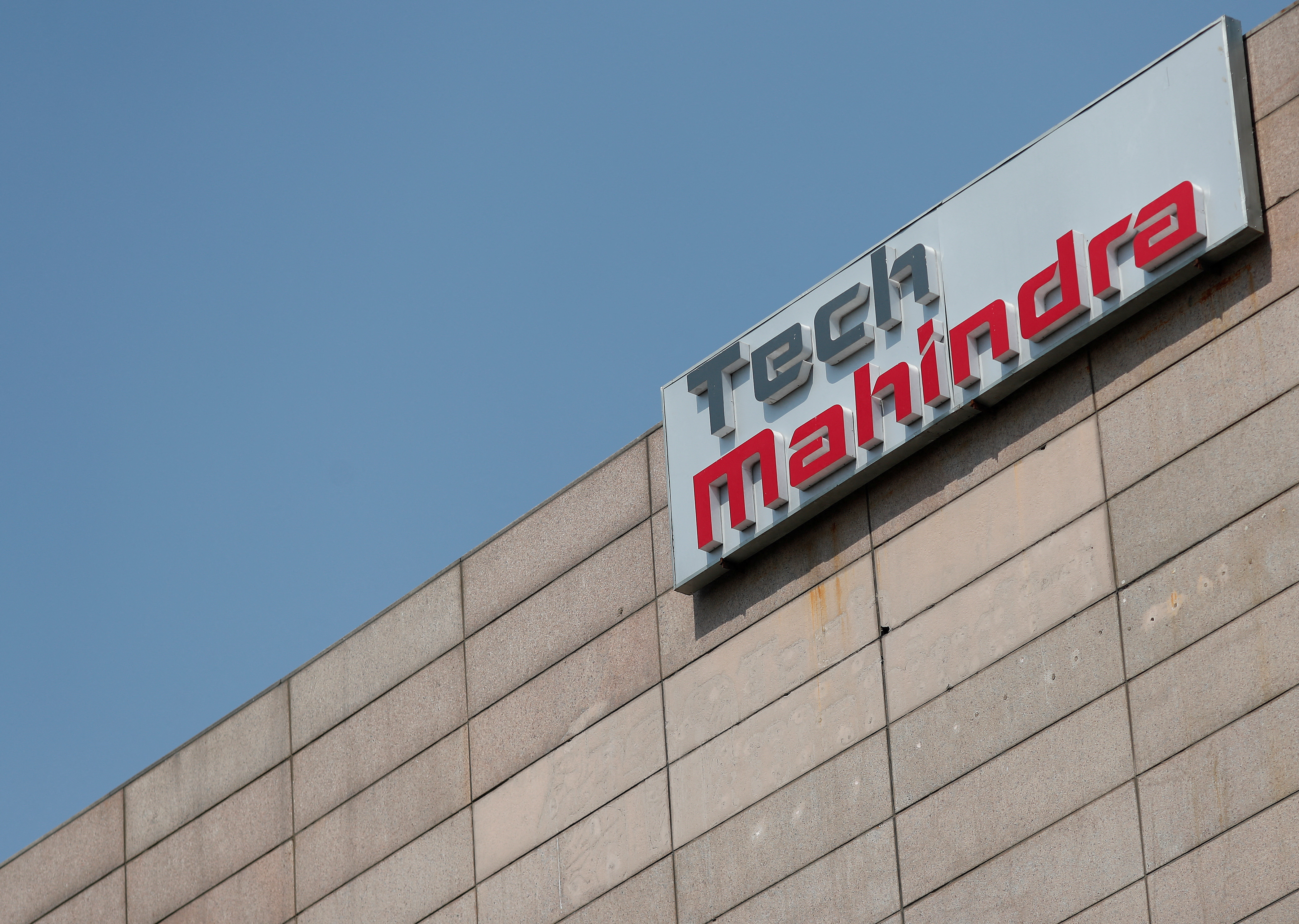 Tech Mahindra logo is seen on its office building in Noida